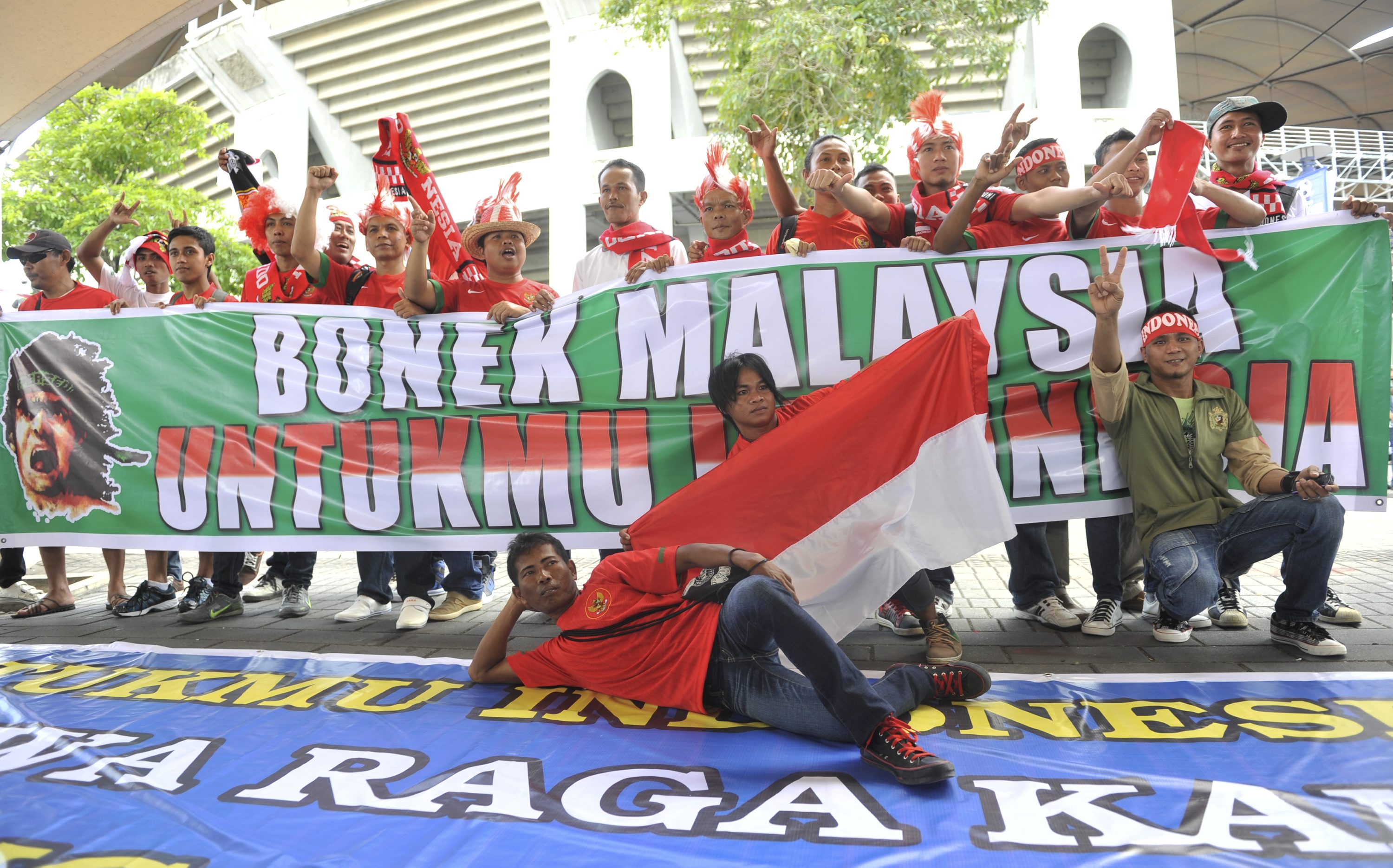 Sejumlah suporter Indonesia berpose di depan stadion Bukit Jalil, Kuala Lumpur, Malaysia.