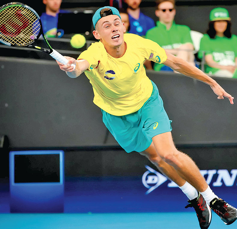 Petenis Australia Alex de Minaur meloncat ketika mengembalikan bola ke arah wakil Kanada Denis Shapovalov 