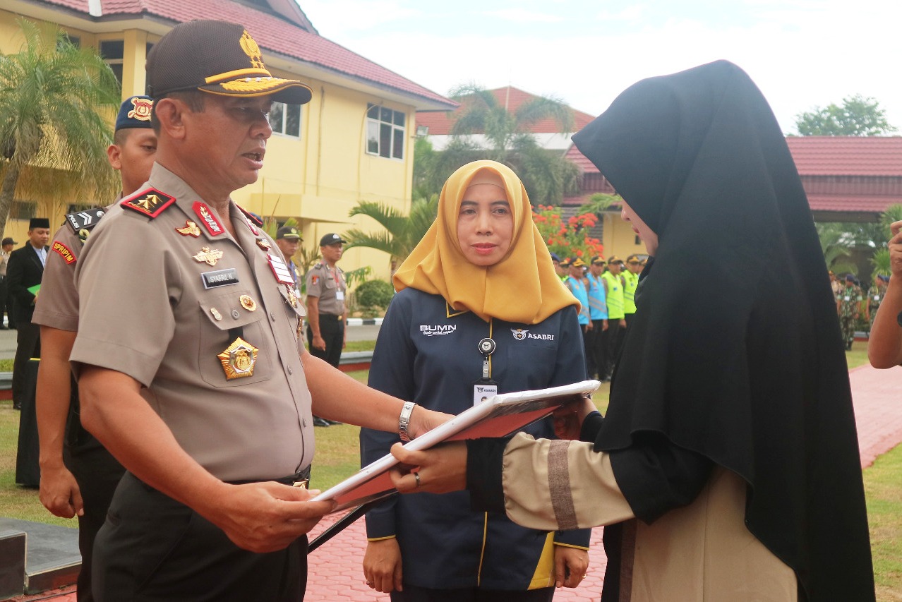 Kapolda Sulteng Irjen Pol Syafril Nursal, Kepala Kantor Cabang ASABRI Palu, Winarti, menyerahkan santunan kepada ahli waris, Novi Sevtiyani.
