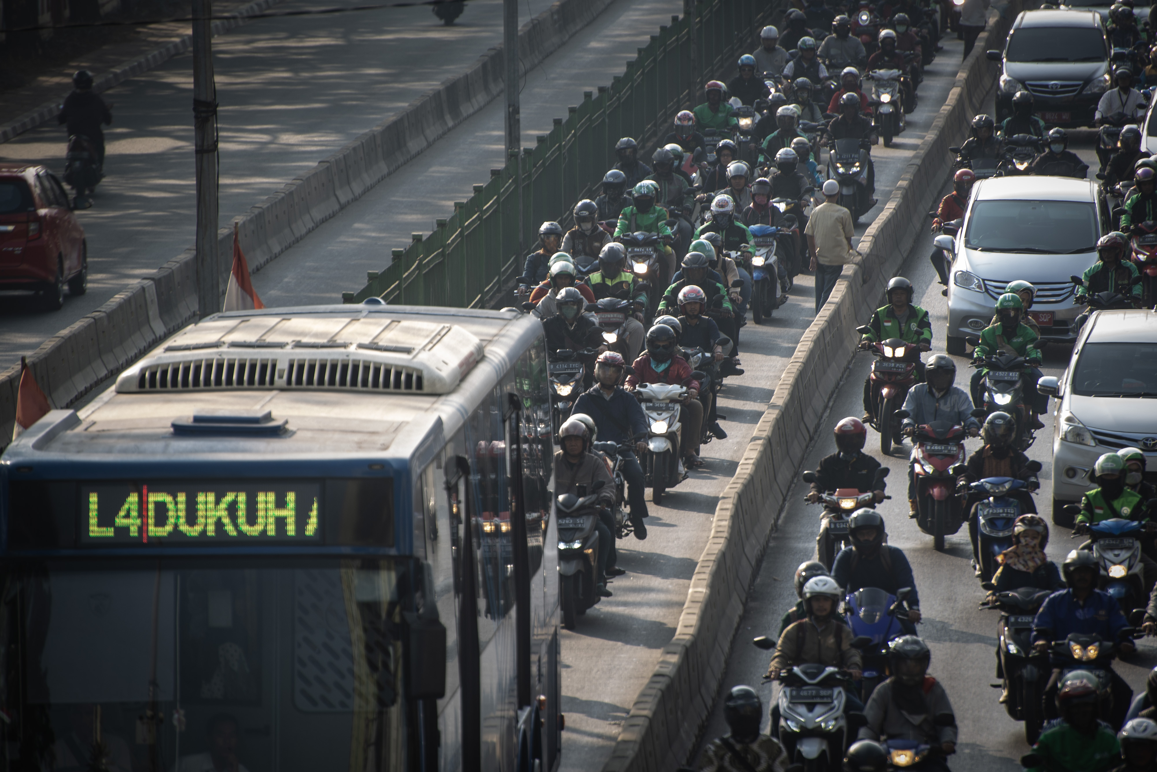Pengendara motor masuk ke jalur Trans-Jakarta