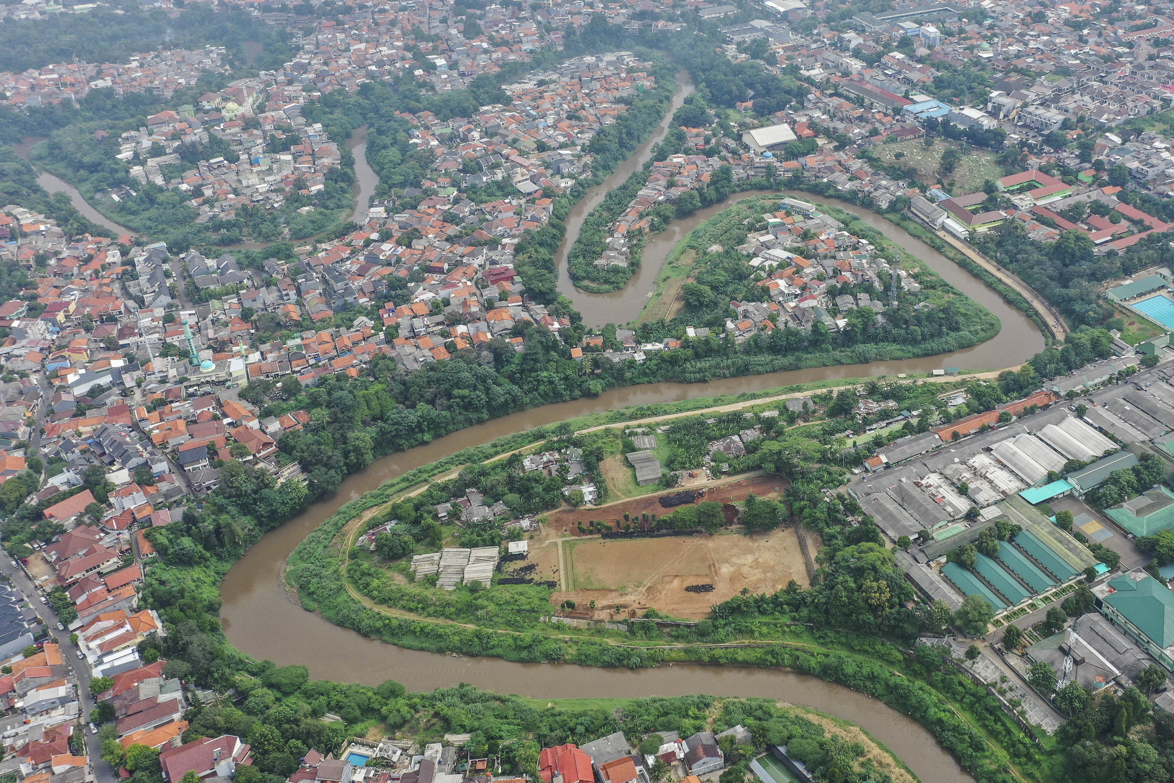 Foto udara aliran Sungai Ciliwung di kawasan Gedong, Pasar Rebo, Jakarta.