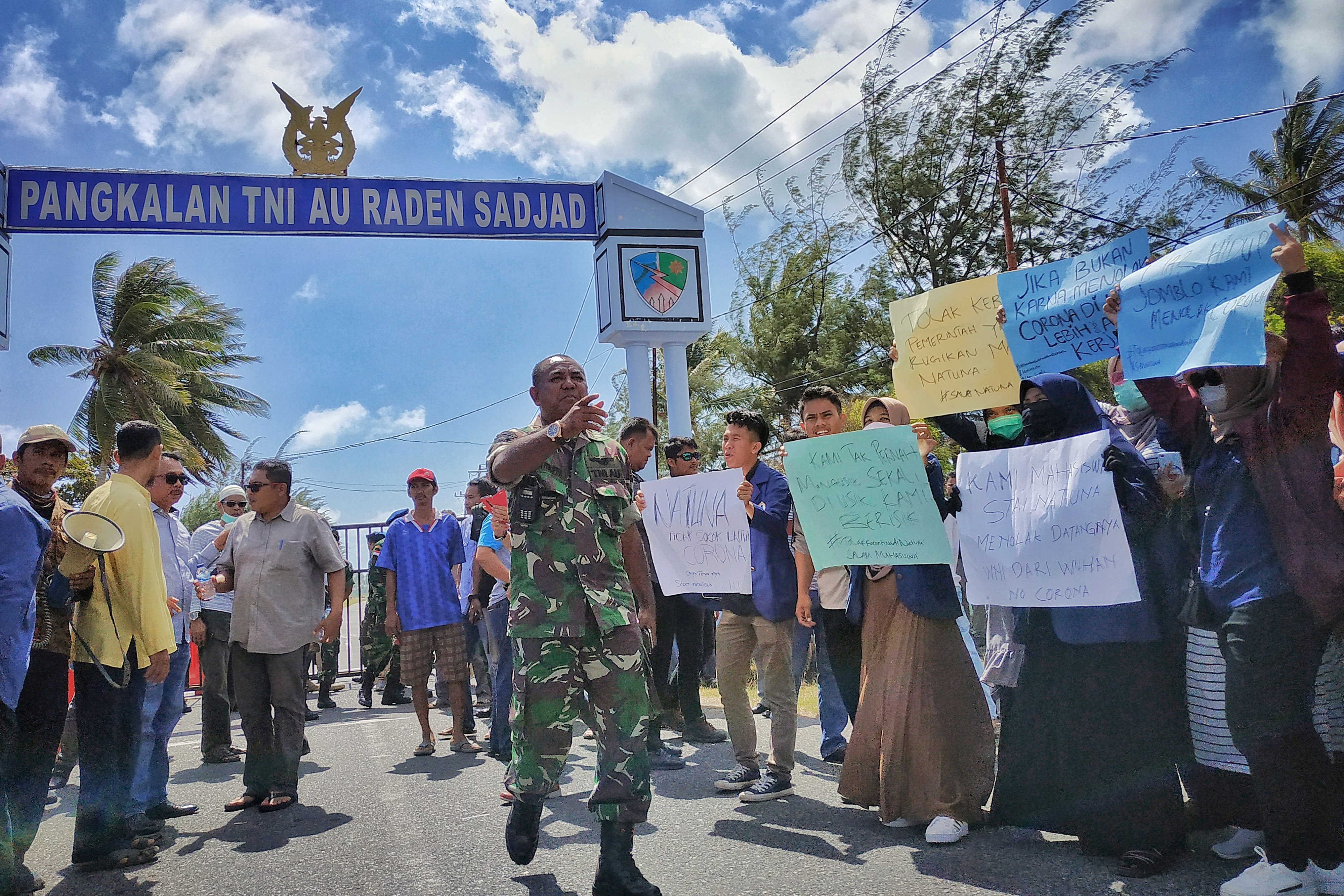 Sejumlah warga Natuna berunjuk rasa di gerbang pangkalan TNI Angkatan Udara Raden Sadjad, Ranai, Natuna, Kepulauan Riau, Sabtu (1/2/2020).