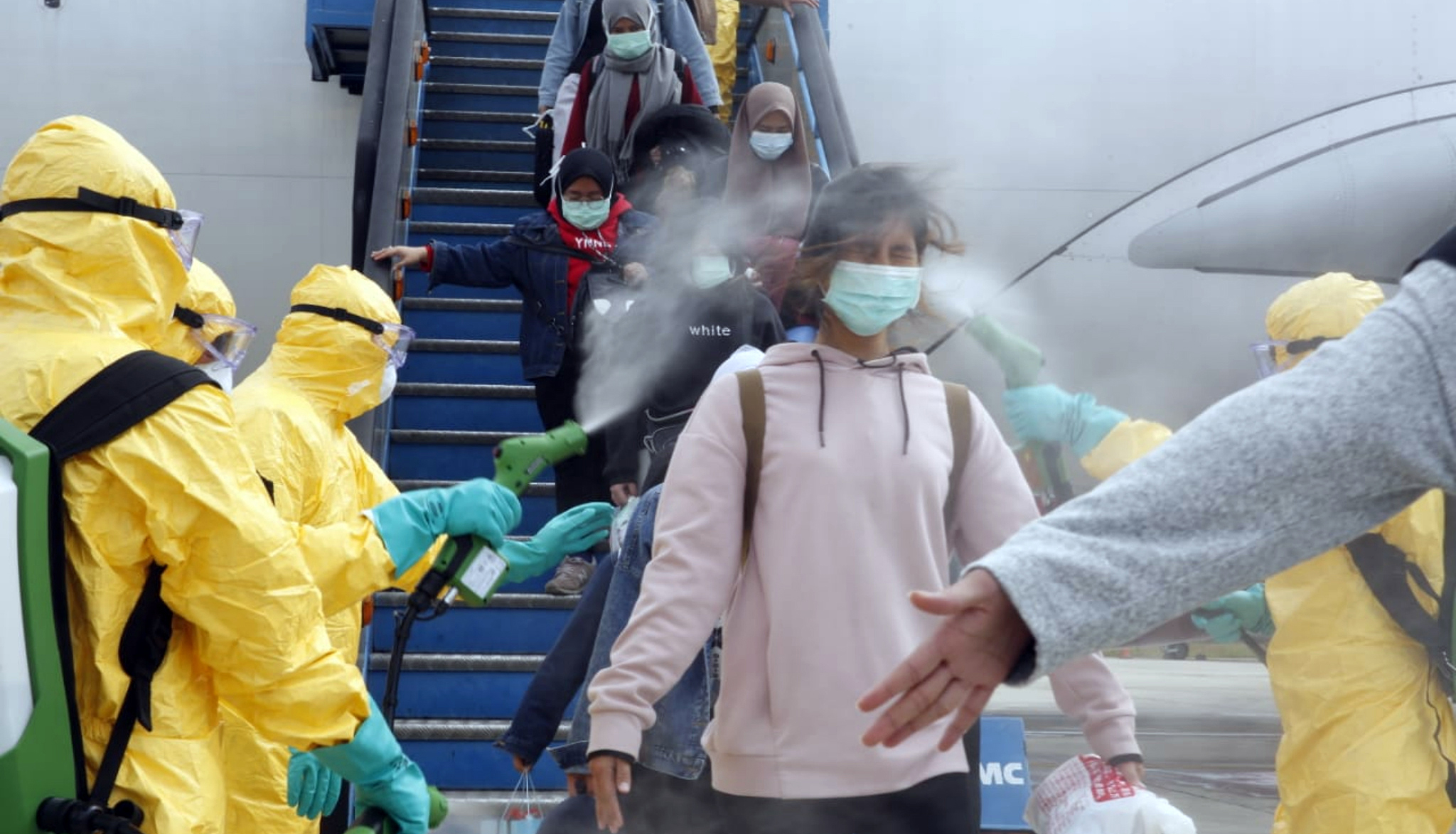  Petugas medis menyemprotkan cairan disinfektan kepada WNI yang dievakuasi dari Wuhan, Tiongkok, setibanya di Bandara Hang Nadim, Batam.