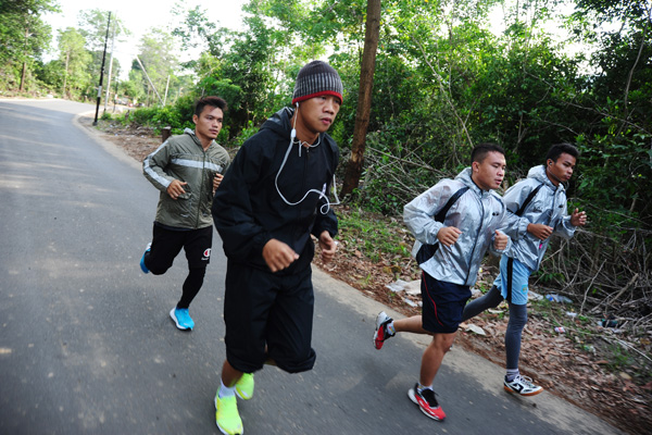 Petinju Daud Yordan (kedua kiri) melakukan latihan lari bersama asuhannya, empat petinju Sasana 24/7 Daud Yordan Boxing Club di Kecamatan Su