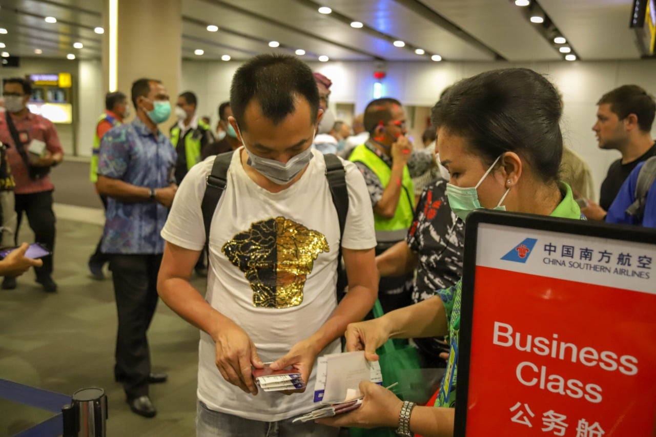 Petugas Bandara Ngurah Rai Bali memeriksa tiket pesawat para penumpang asal Tiongkok yang akan pulang ke Shanghai, Selasa (4/2/2020).