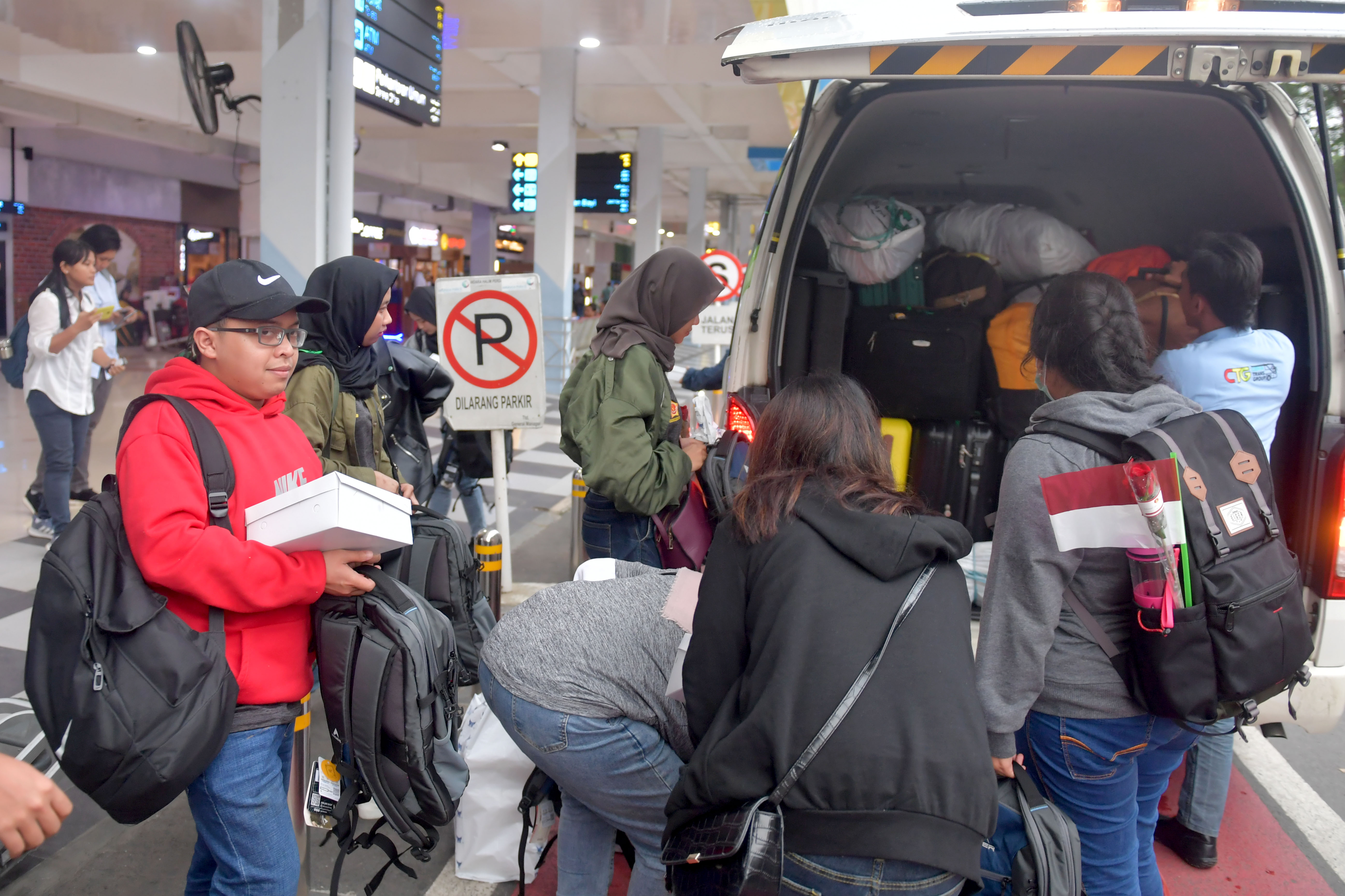 Sejumlah WNI yang dievakuasi dari Provinsi Hubei, Tiongkok, menurunkan barang dari mobil ketika tiba di Bandara Halim Perdana Kusuma.