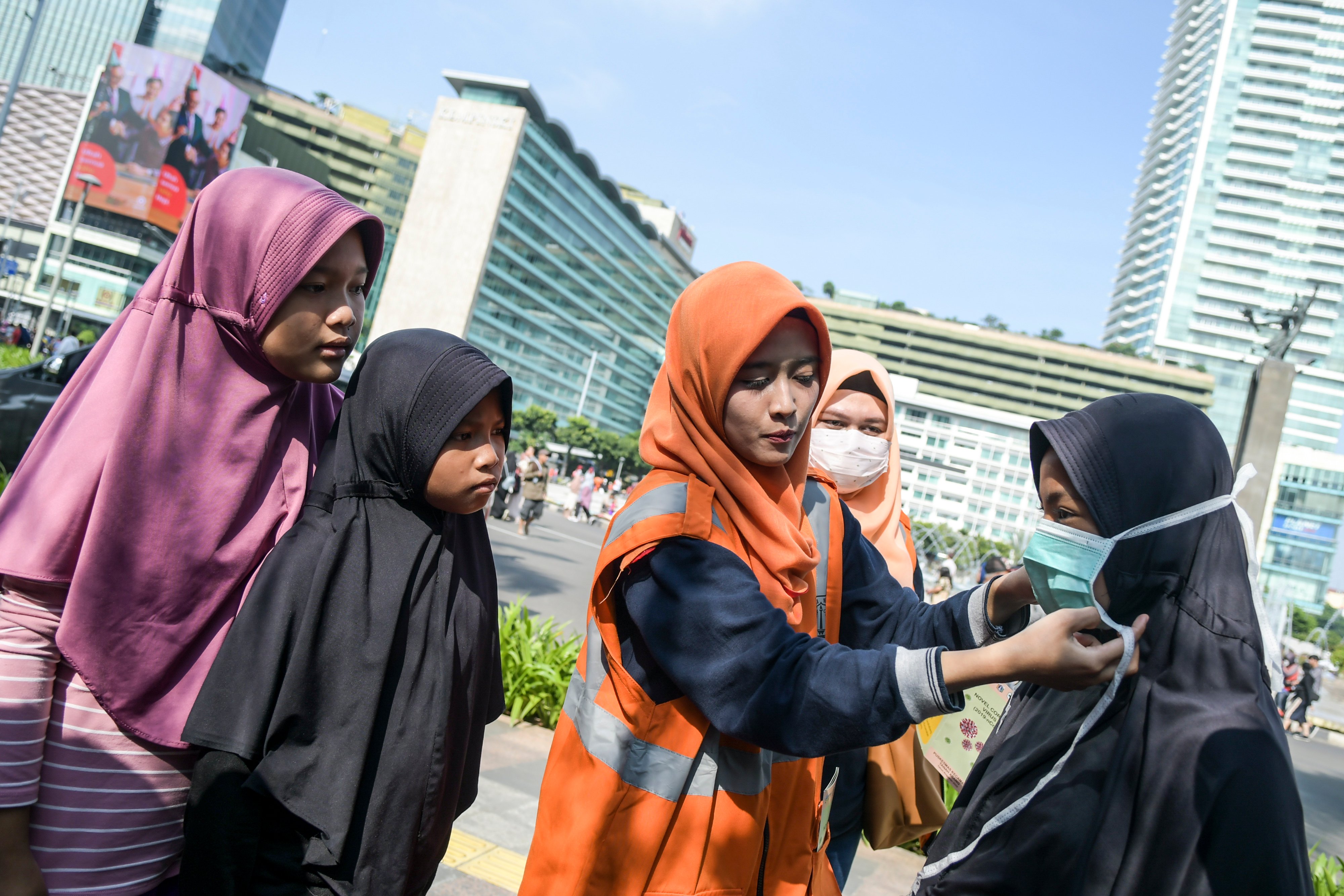 Petugas Tanggap COVID-19 Pemprov DKI Jakarta memberikan sosialisasi tata penggunaan masker kepada masyarakat pada Car Free Day.