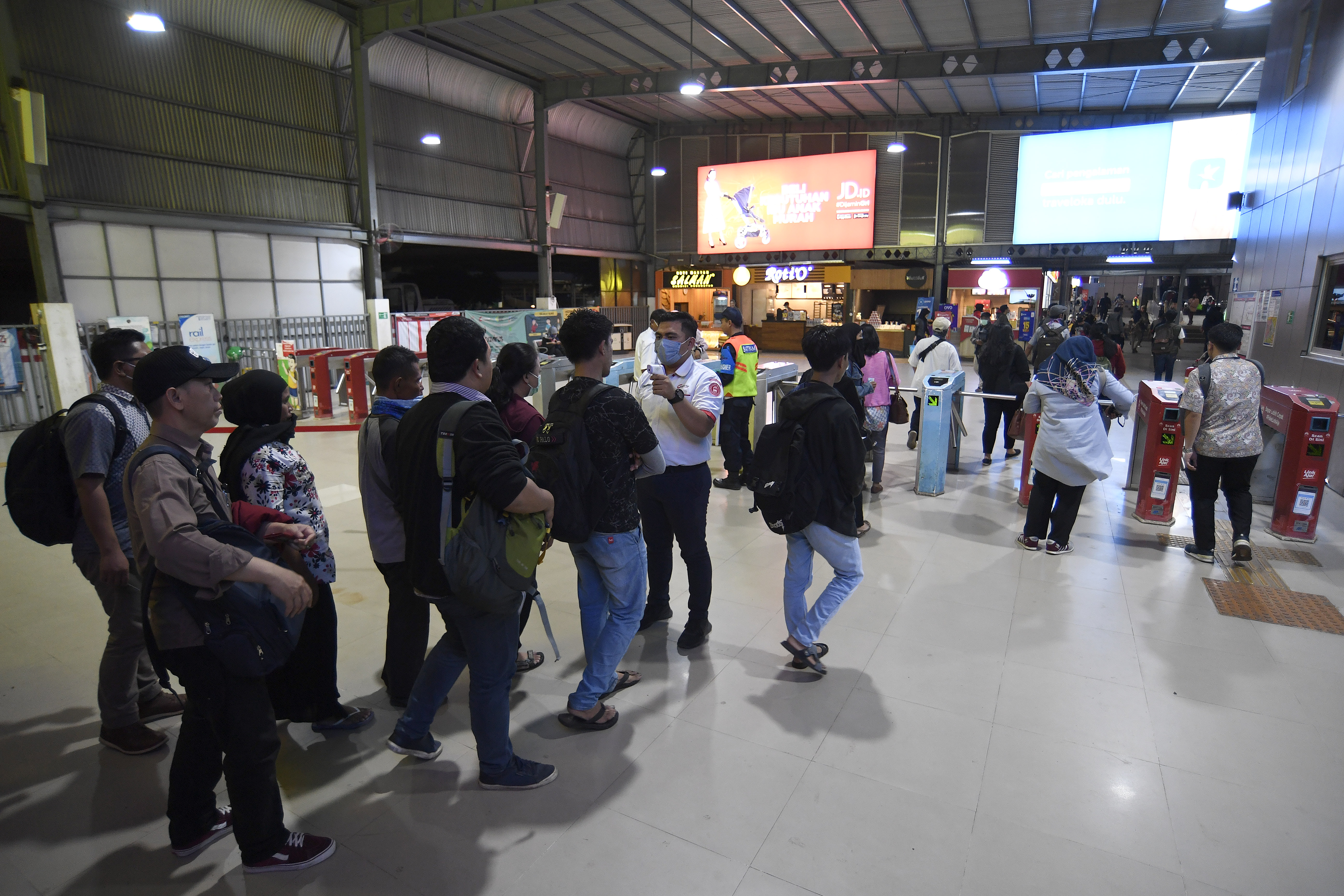  Petugas memeriksa suhu tubuh calon penumpang KRL Commuter Line di Stasiun Tanah Abang, Jakarta, Selasa (17/3/2020)