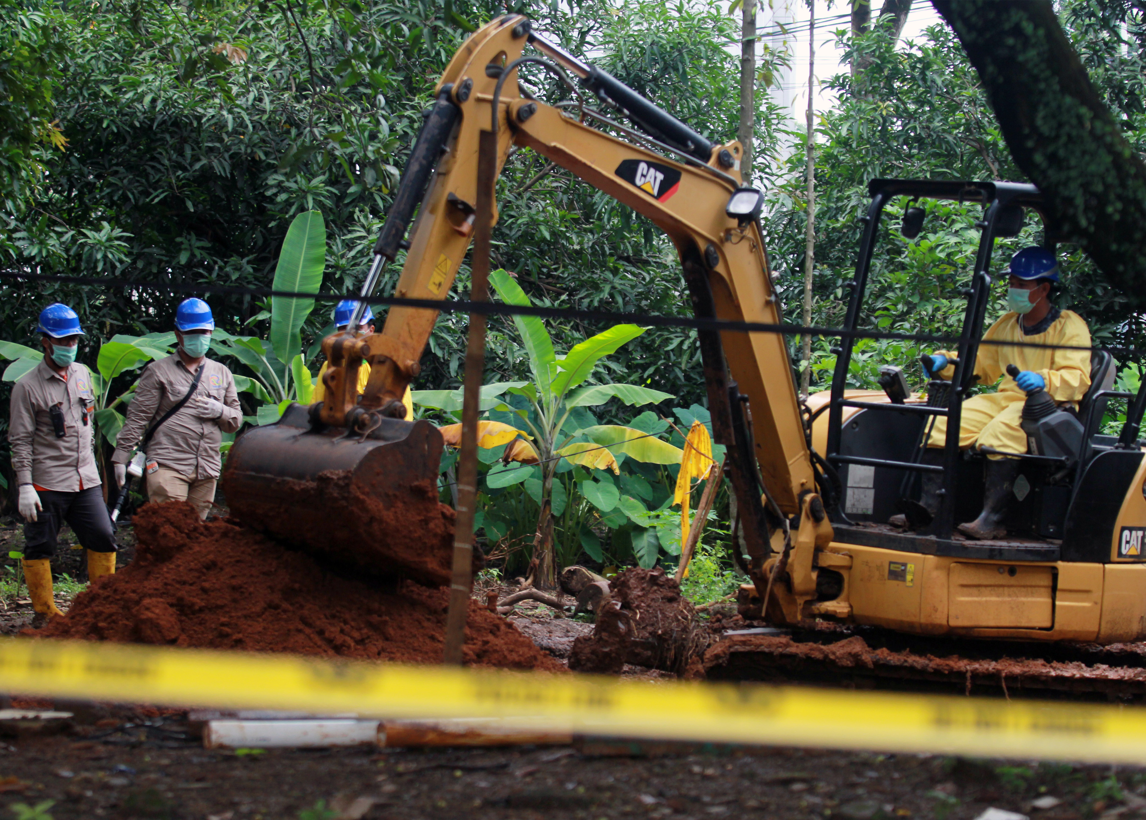 Petugas melakukan dekontaminasi tahap akhir dengan melakukan pengerukan tanah daerah terkena paparan tinggi radioaktif.