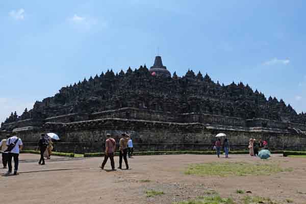 Sejumlah wisatawan berjalan di halaman Candi Borobudur di Kompleks Taman Wisata Candi Borobudur, Magelang, Jawa Tengah, Kamis (13/2)