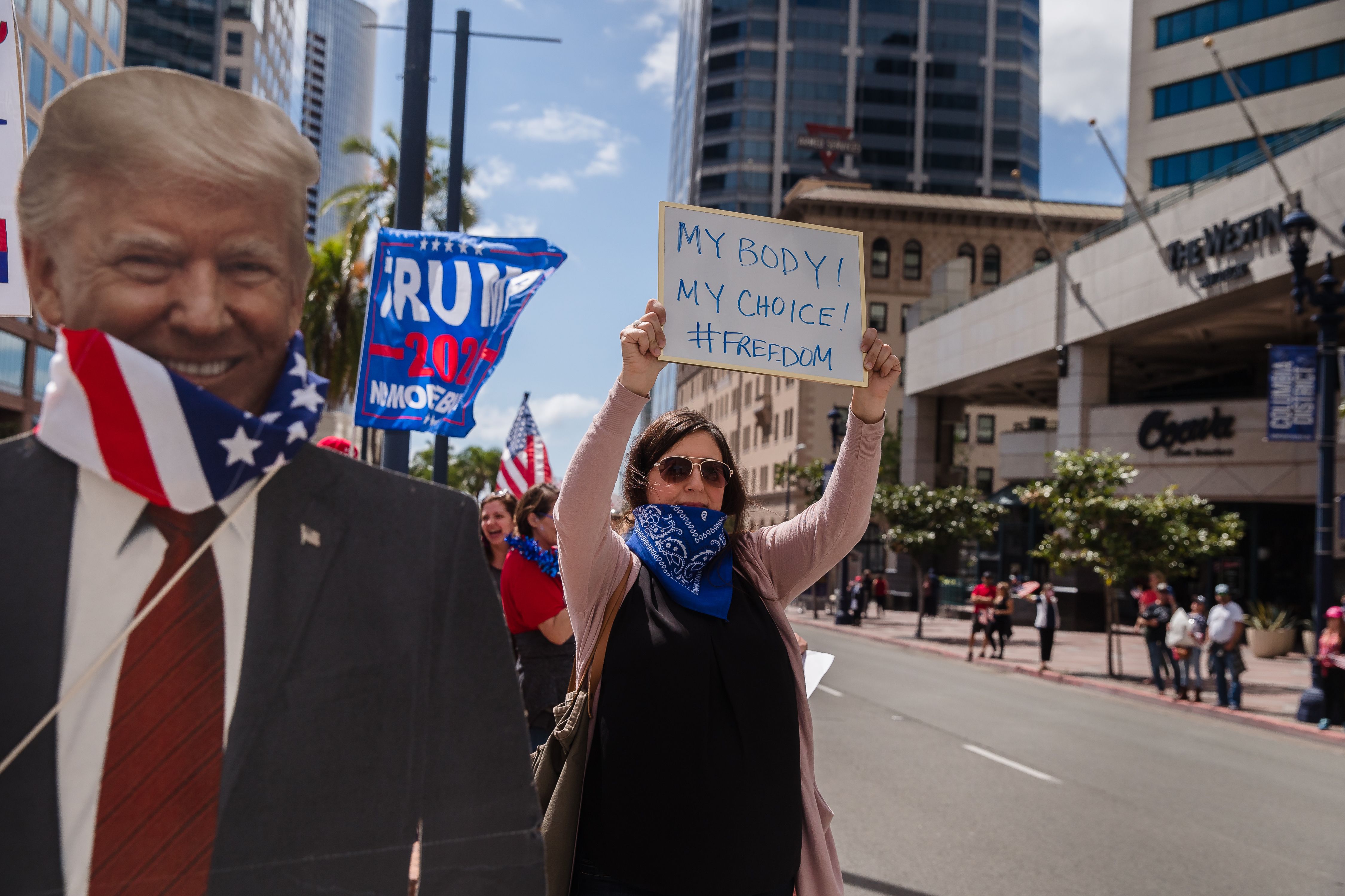 Para pengunjuk rasa turun ke jalan menolak kebijakan lockdown warga California dalam upaya mencegah penularan covid-19 di San Diego, AS.