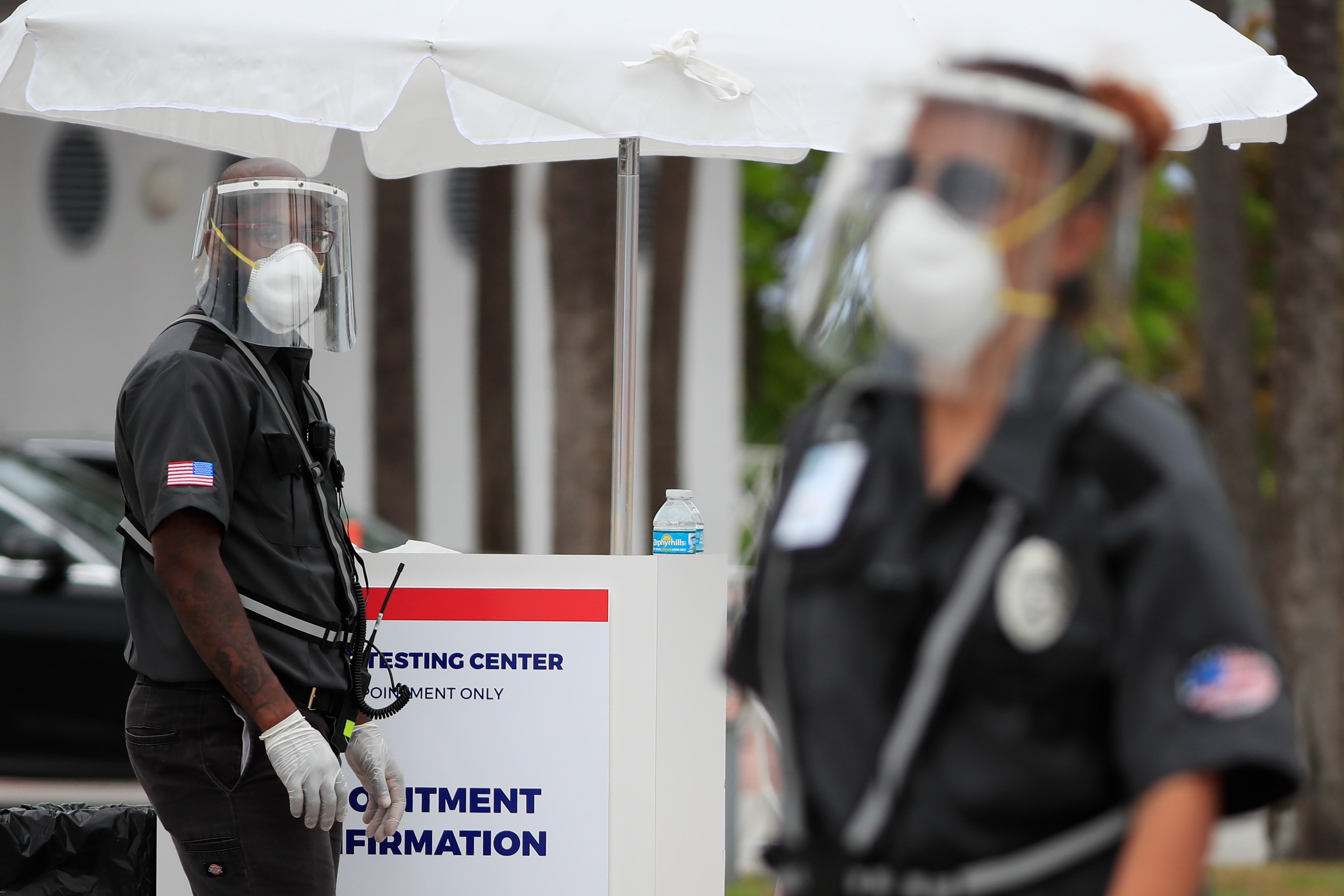 Petugas keamanan di Miami, Florida, menggunakan alat pelindung saat berpatroli di tengah pandemi covid-19.