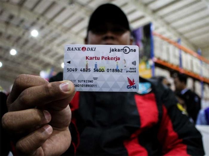 Ilustrasi-Pekerja menunjukkan Kartu Pekerja saat pendistribusian dan uji coba di Jakgrosir, Pasar Induk Kramat Jati, Jakarta.