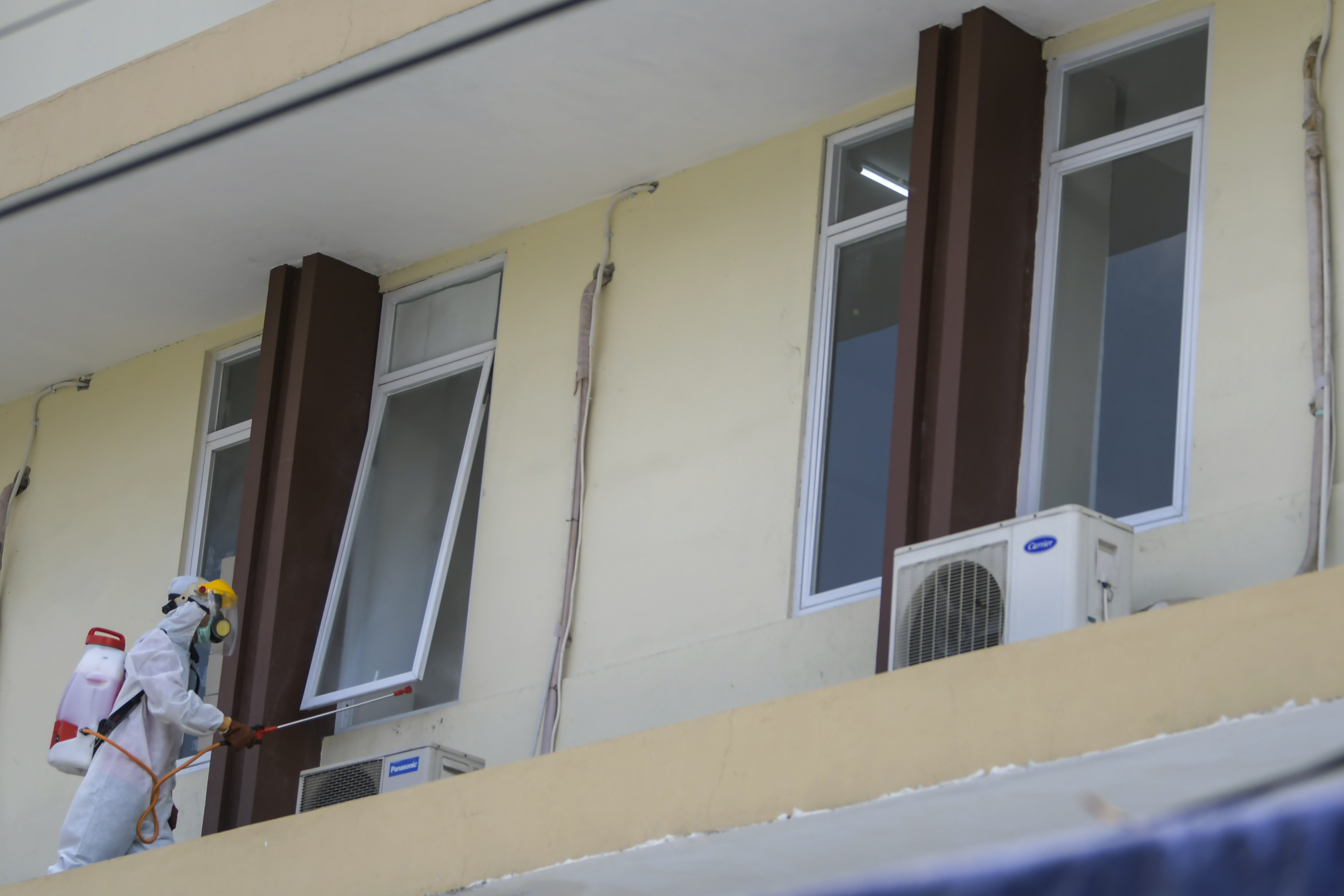 Petugas Palang Merah Indonesia (PMI) menyemprotkan cairan disinfektan di asrama Sekolah Tinggi Teknologi Bethel, Jakarta, Jumat (17/4).