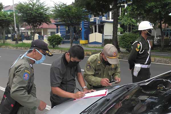 Seorang warga terkena razia karena tidak menggunakan masker di tempat umum, di Kabupaten Banyumas, kemarin.