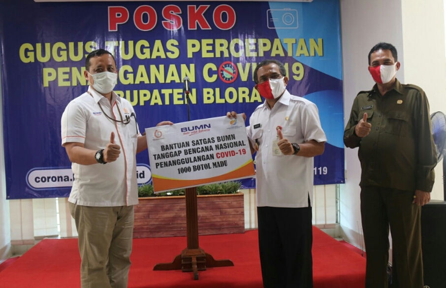 Direktur Operasional Perum Perhutani Pusat Bambang Catur Wahyudi (kiri) memberikan bantuan seribu botol kepada warga Blora.