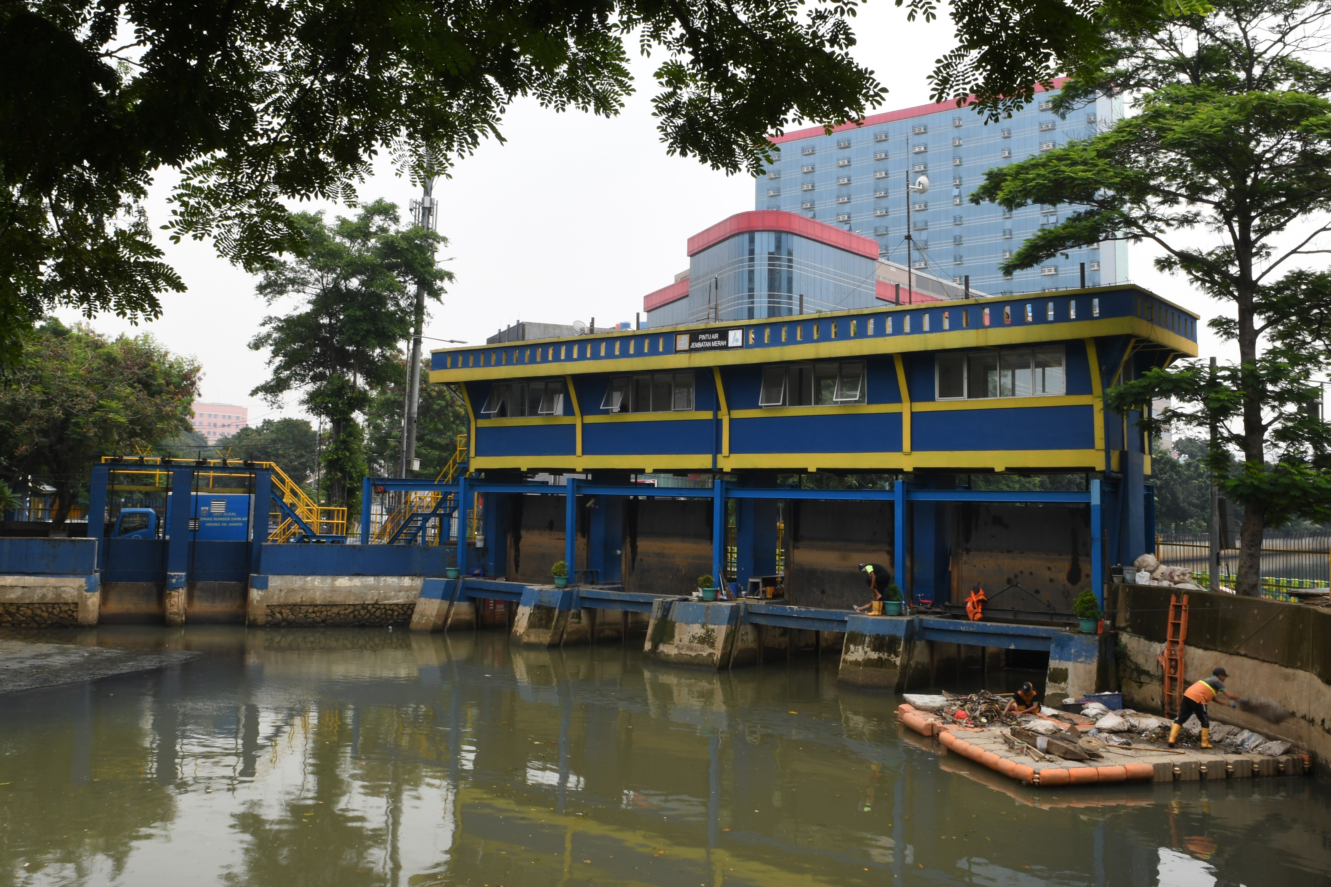 Petugas Penanganan Prasarana dan Sarana Umum (PPSU) membersihkan sampah yang berada di Pintu Air jembatan Merah, Jakarta, Rabu (15/4). 