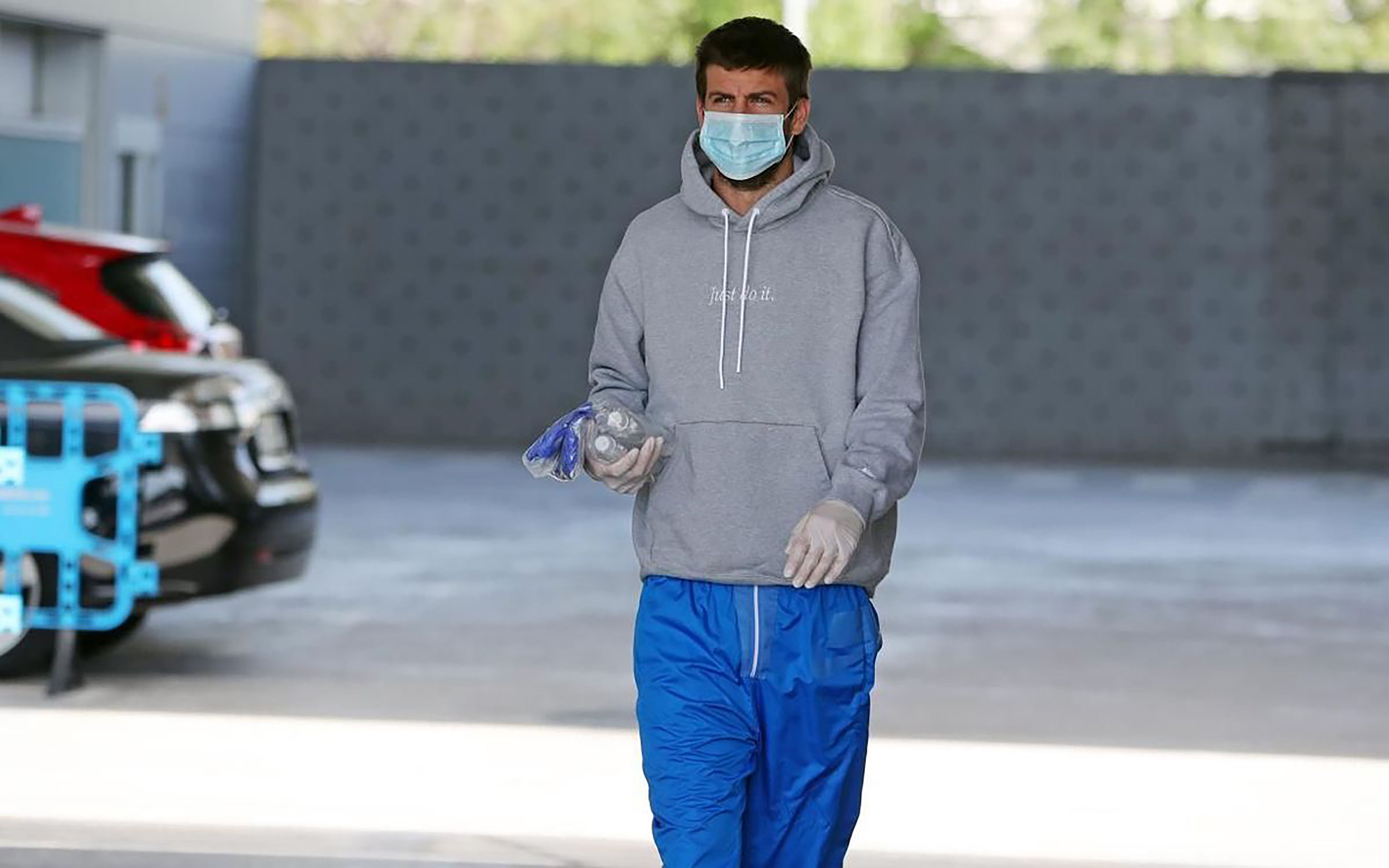 Bek Barcelona Gerard Pique memakai masker dan sarung tangan saat berada di Sant Joan Despi dekat Barcelona, Jumat (6/5/2020).