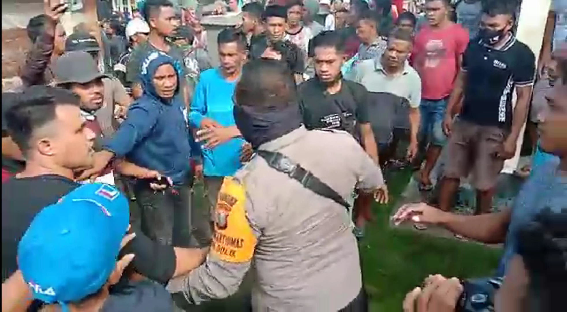 Petugas Kepolisian menghadang warga Desa Dolik Kabupaten Halmahera Selatan yang berdemo di Kantor Desa Dolik.