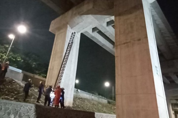 Petugas mengevakuasi seekor kucing dari sela tiang lintasan LRT setinggi 15 meter di Kecamatan Makasar, Kamis (21/5) malam.