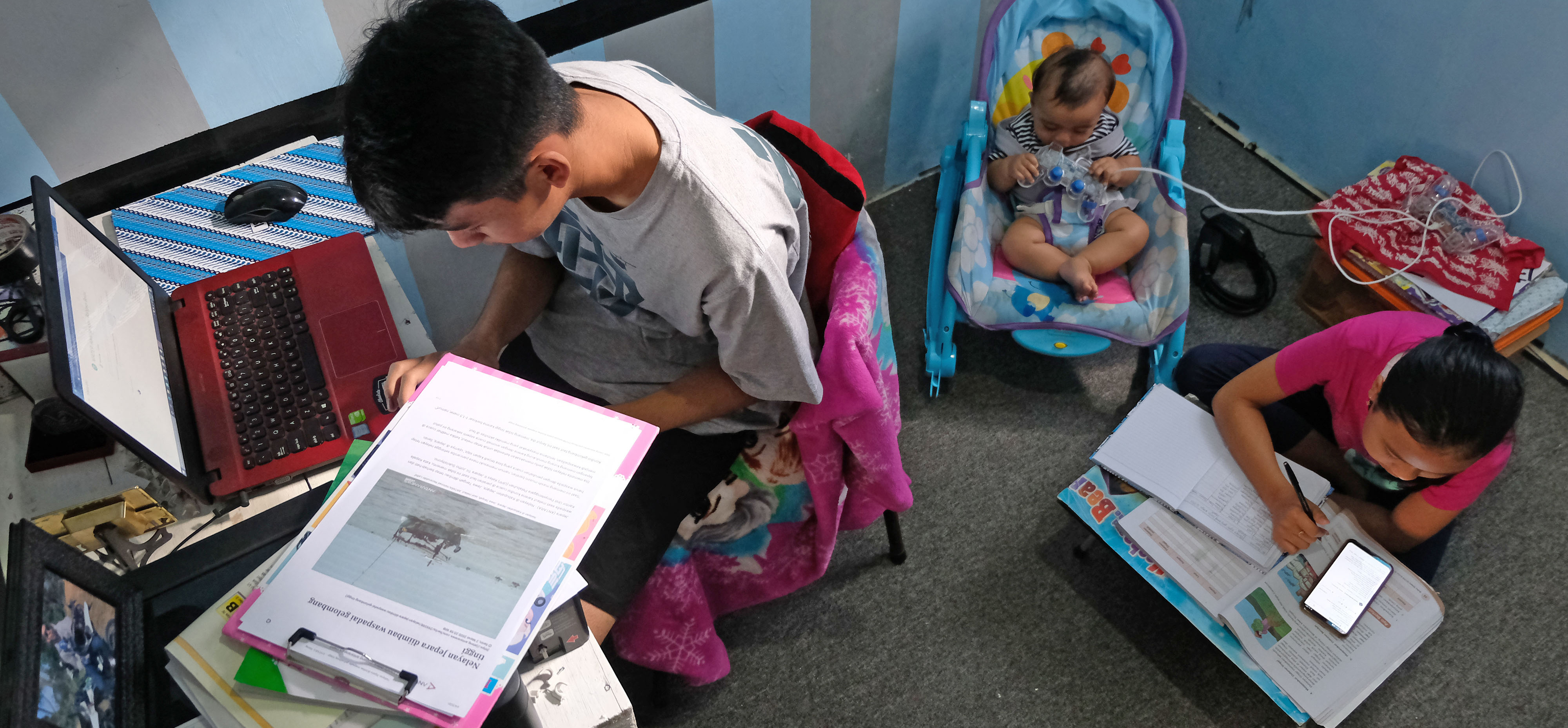 Pelajar mengerjakan tugas sekolah yang diberikan guru secara online di rumahnya