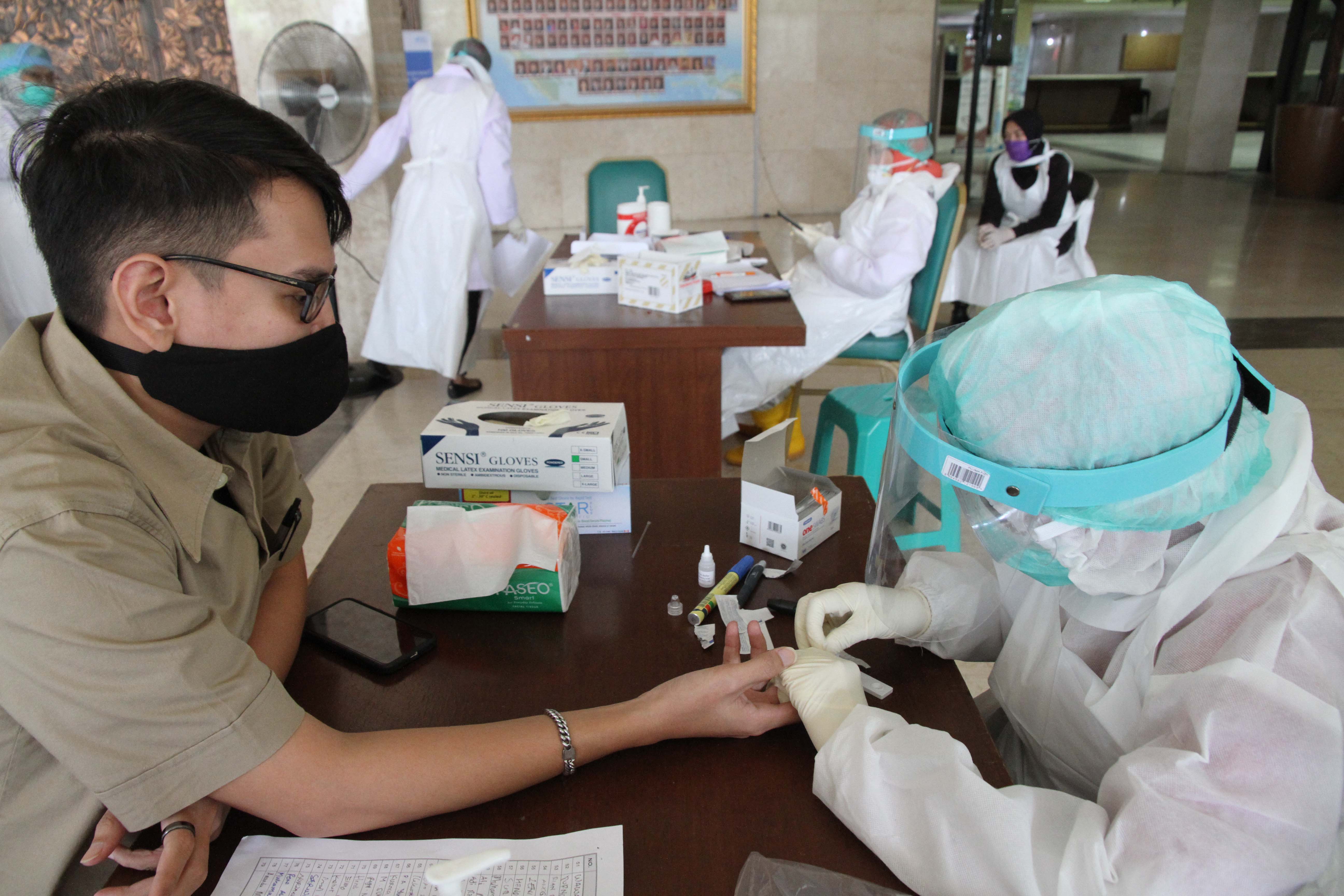 Petugas medis mengambil sampel darah para ASN untuk Rapid Test virus Covid-19 di Lobi Gedung DPD, Kompleks Parlemen, Senayan, Jakarta