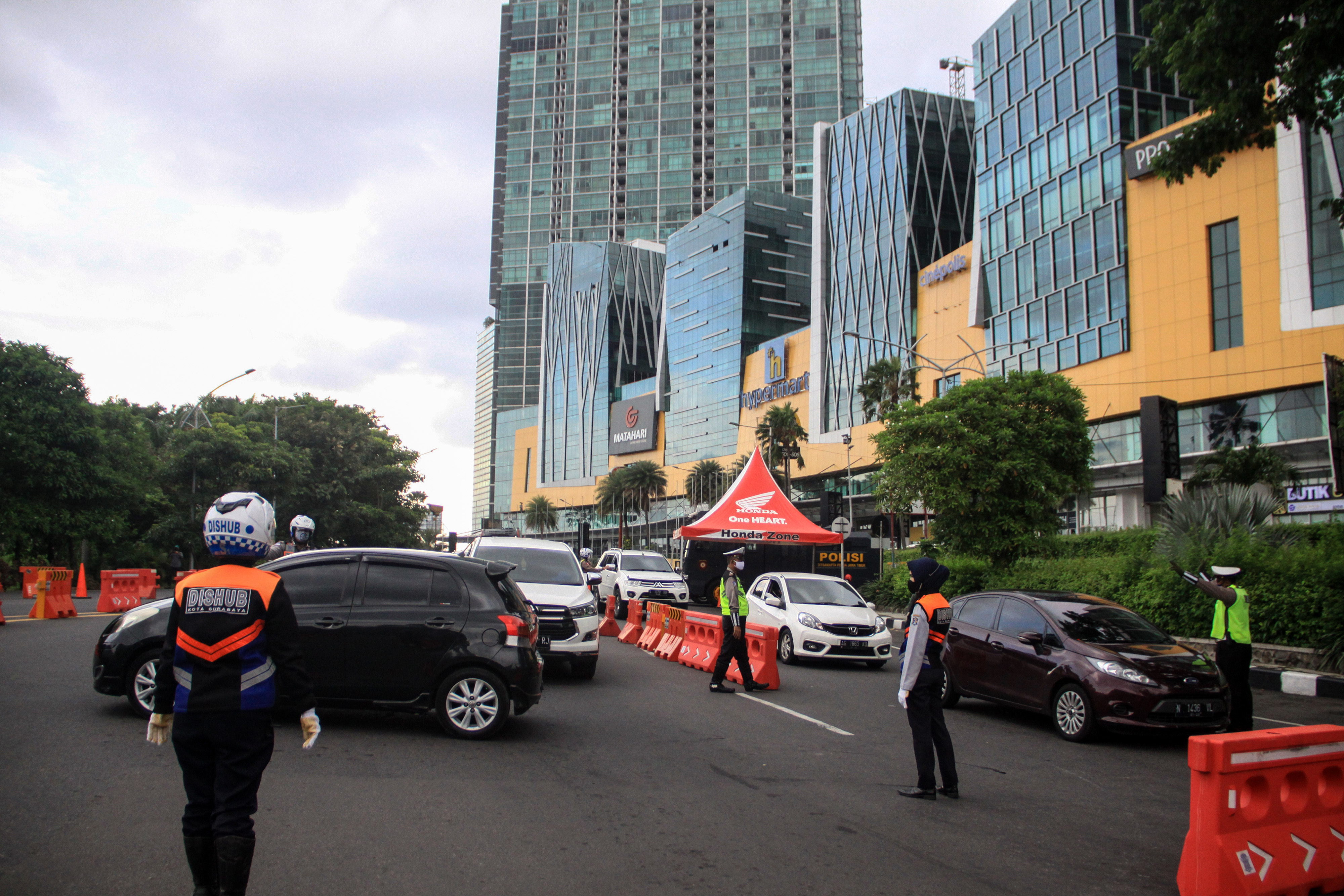 Petugas Dishub meminta kendaraan untuk berputar balik karena tidak berkepentingan saat ingin memasuki Kota Surabaya di Bundaran Waru (10/5)