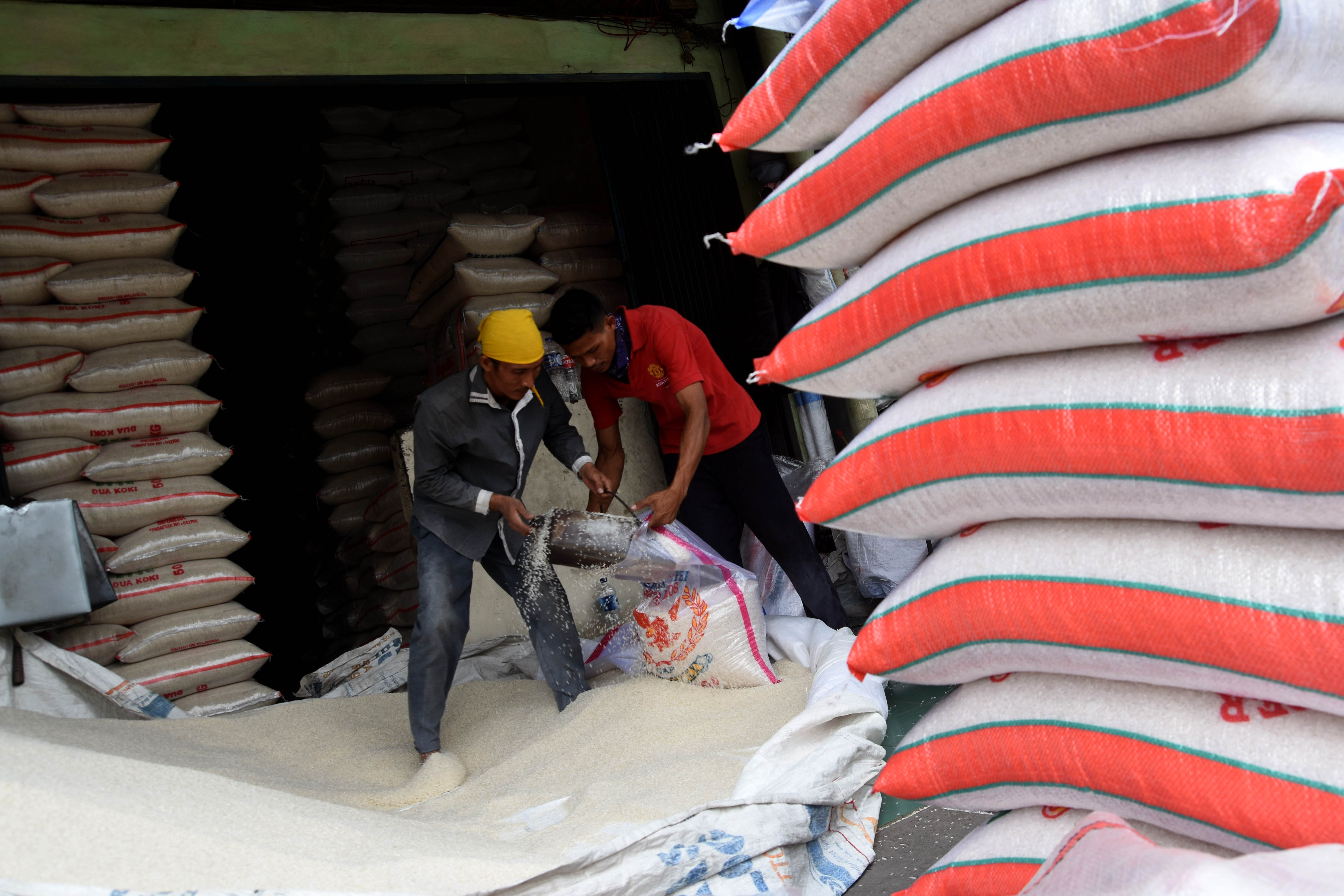 Pekerja melakukan pengepakan beras di Pasar Induk Beras Cipinang, Jakarta, Senin (20/5/2019).