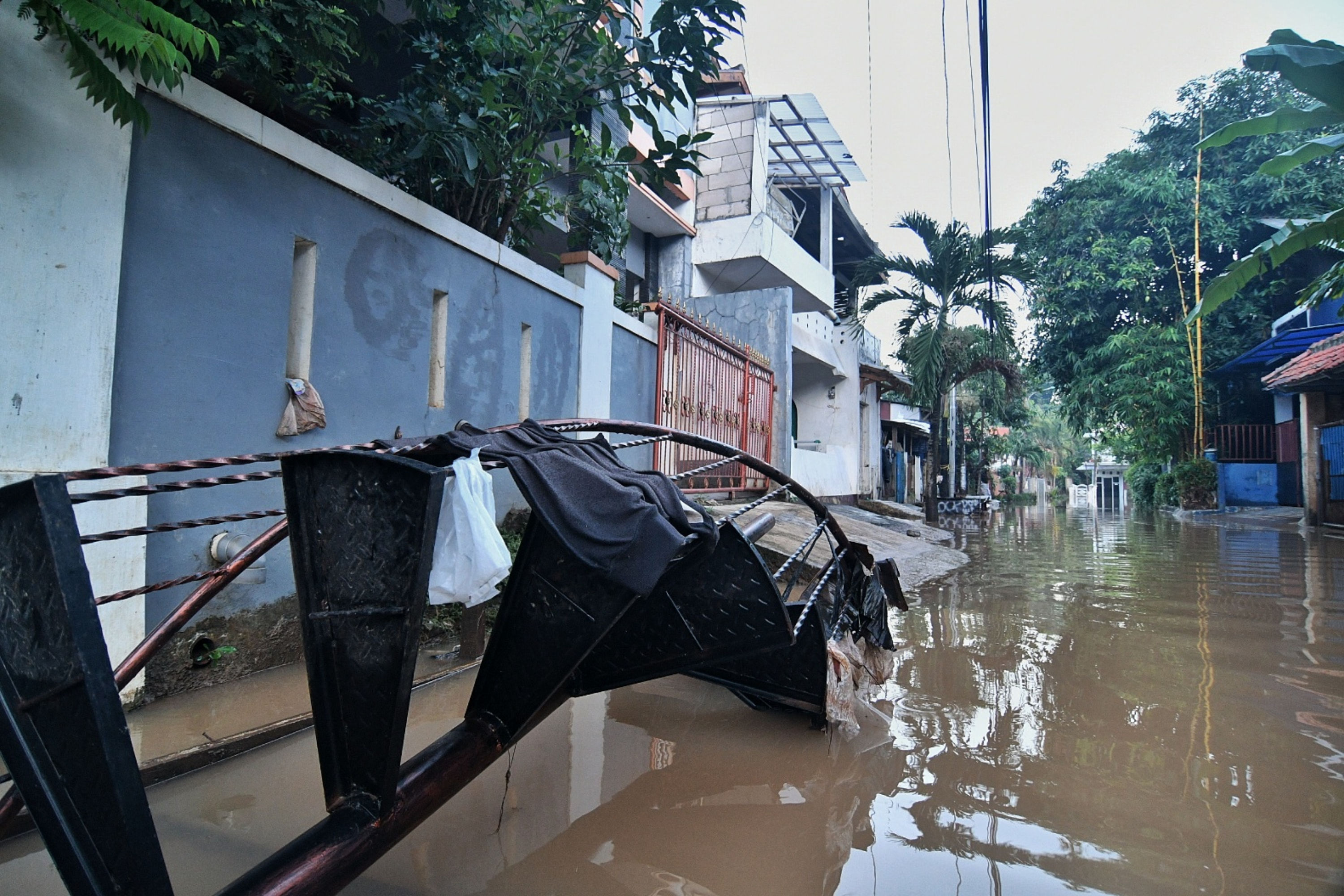 Warga membersihkan rumahnya saat banjir mulai surut di kawasan rw.08 Kelurahan Cawang, Jakarta Timur, Selasa (19/5).