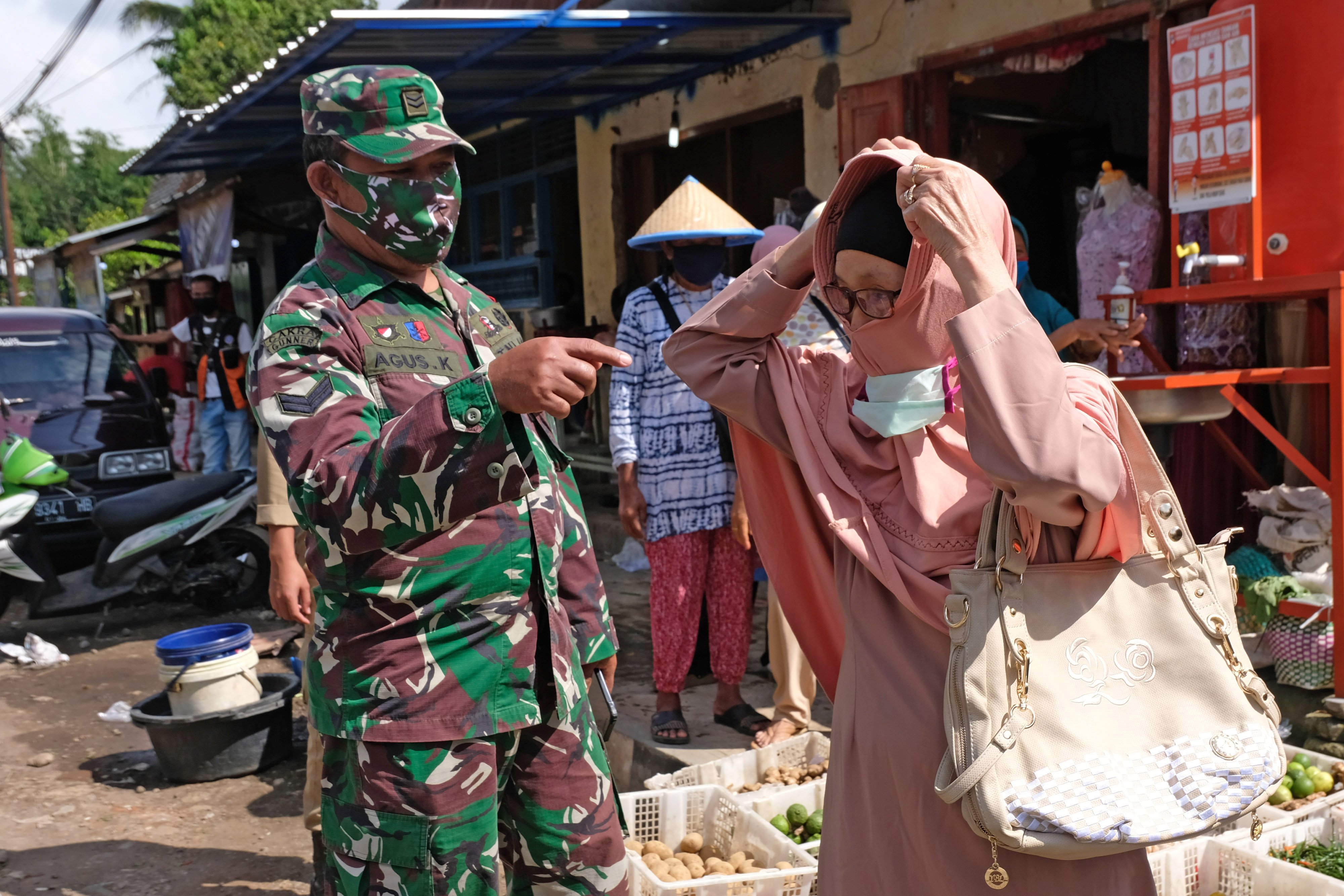 Personel TNI anggota tim Gugus Percepatan Penanganan COVID-19 melakukan sosialisasi kewajiban memakai masker di tempat umum 