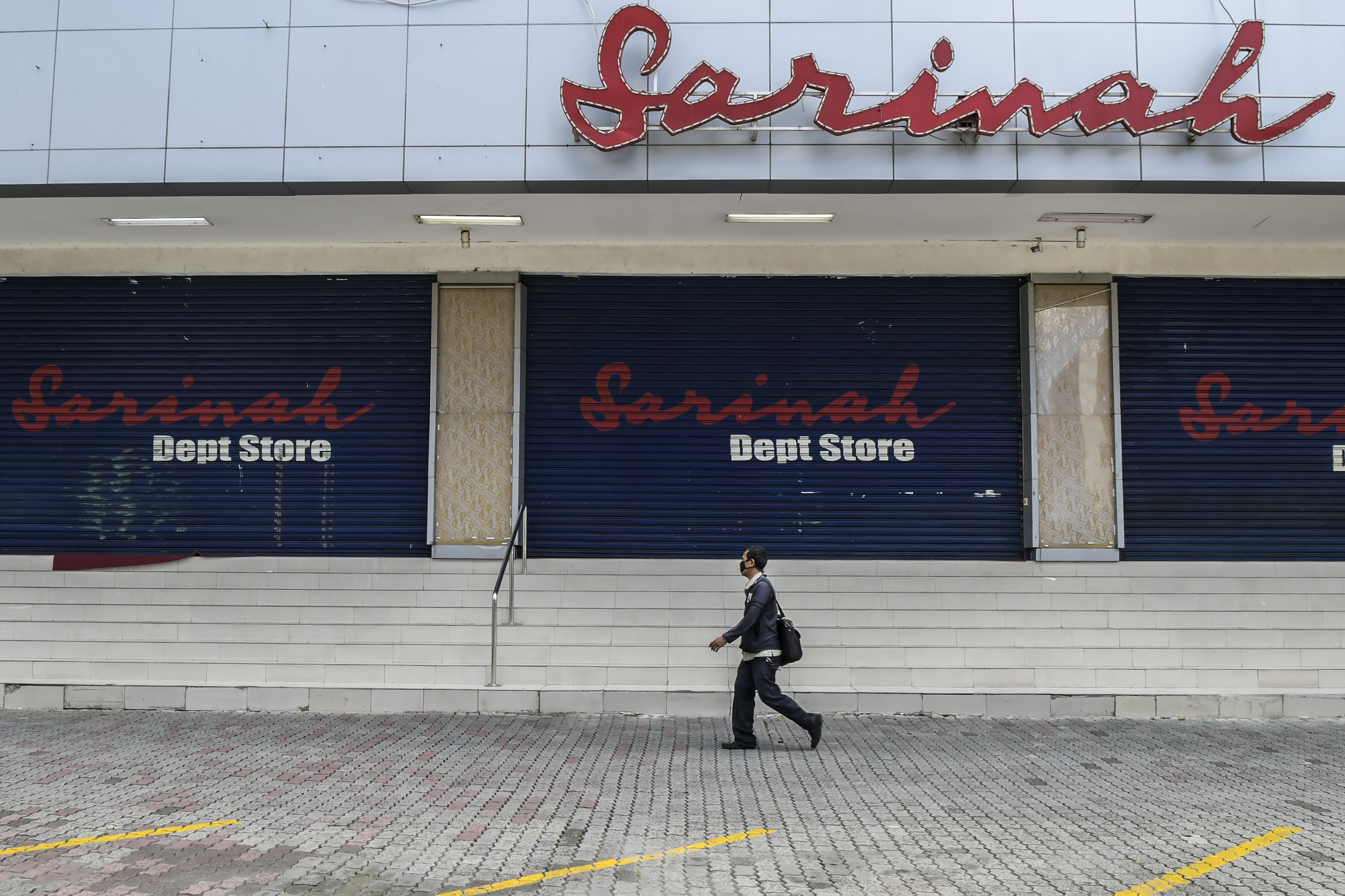 Warga melintasi pertokoan di Plaza Sarinah yang tutup selama PSBB.