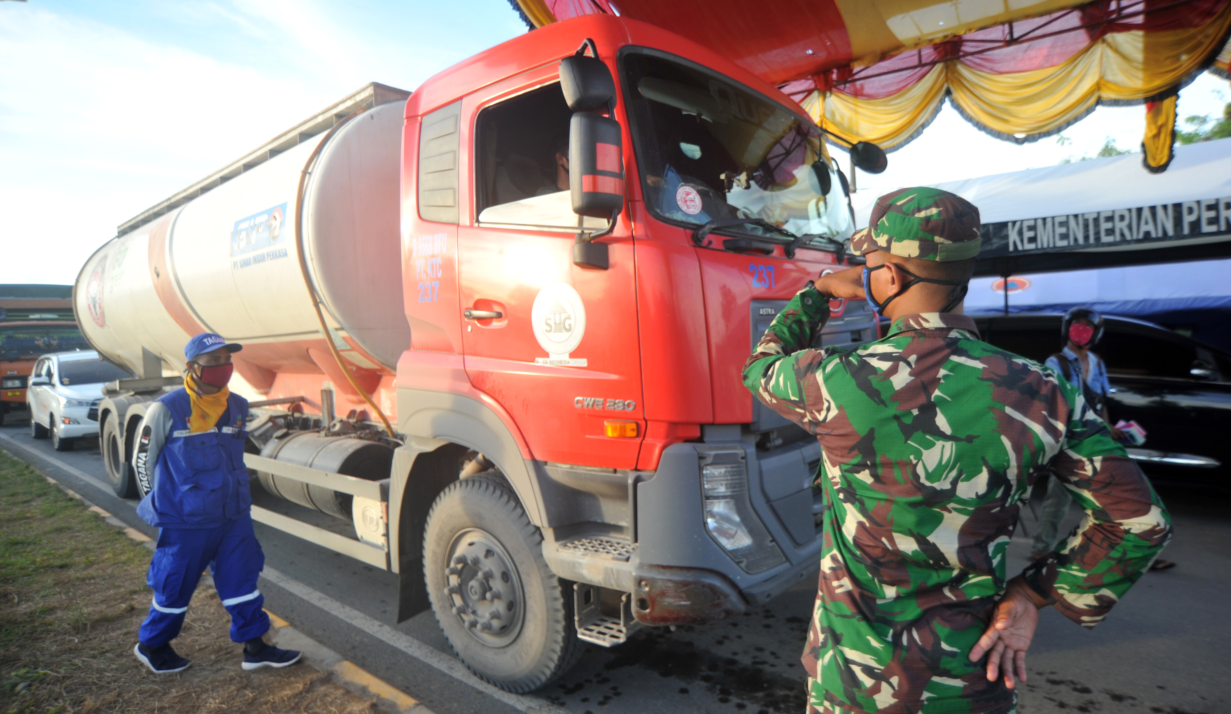 Petugas memeriksa kendaraan yang akan memasuki Kota Padang, Sumatera Barat, Senin (27/4). 