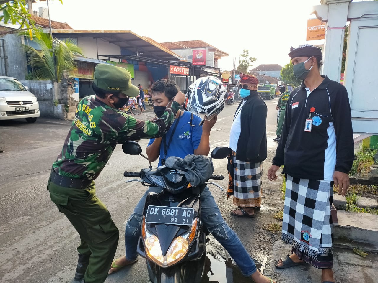 Petugas dari kelurahan Pedungan, Denpasar Selatan melakukan sidak wajib masker yang melintas di wilayah itu, Minggu (3/5).