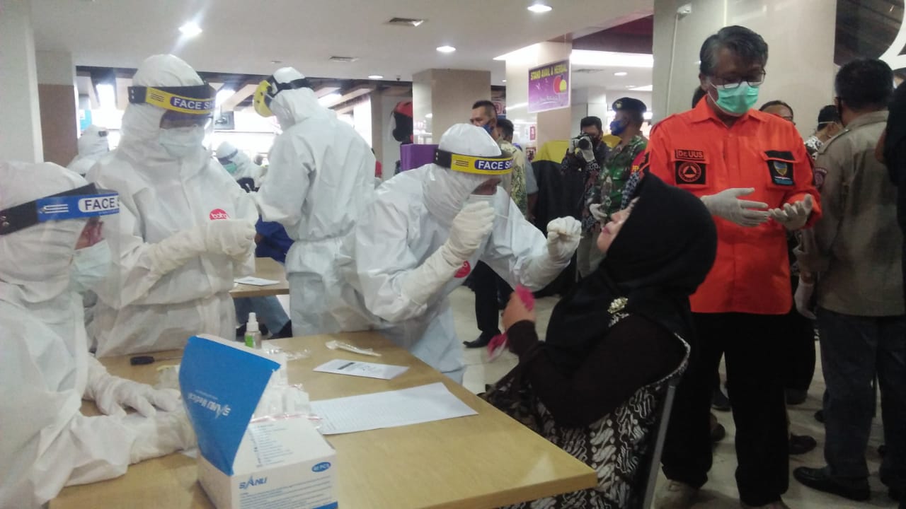 Petugas melakukan swab test massal di sebuah pusat perbelanjaan di Kota Tasikmalaya, Jawa Barat, Selasa (16/6).