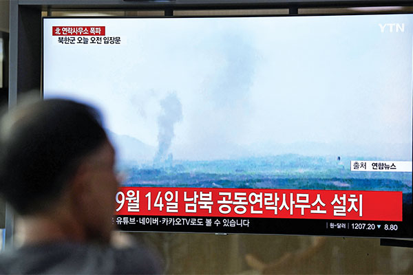 Warga menyaksikan berita televisi yang memperlihatkan asap yang berasal dari ledakan kantor penghubung antar-Korea