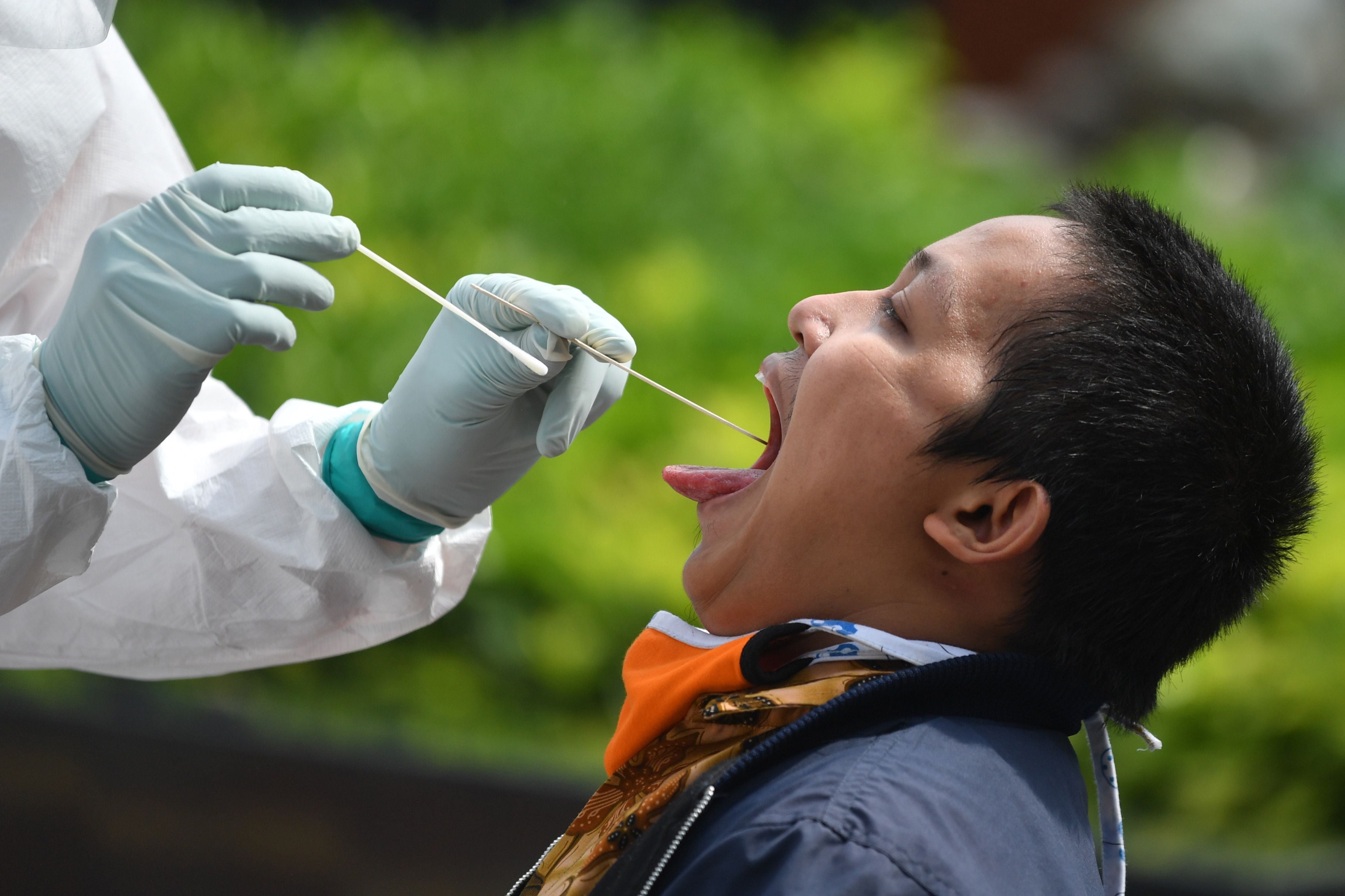 Petugas medis melakukan tes swab kepada warga Jakarta