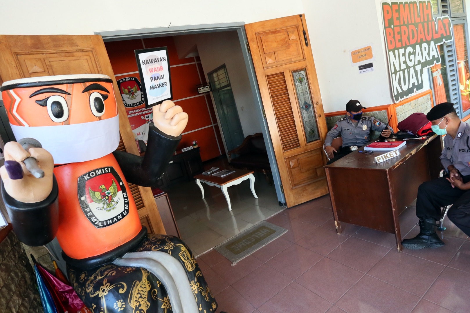 Polisi berjaga di depan pintu kantor KPUD Kota Blitar, Jawa Timur.