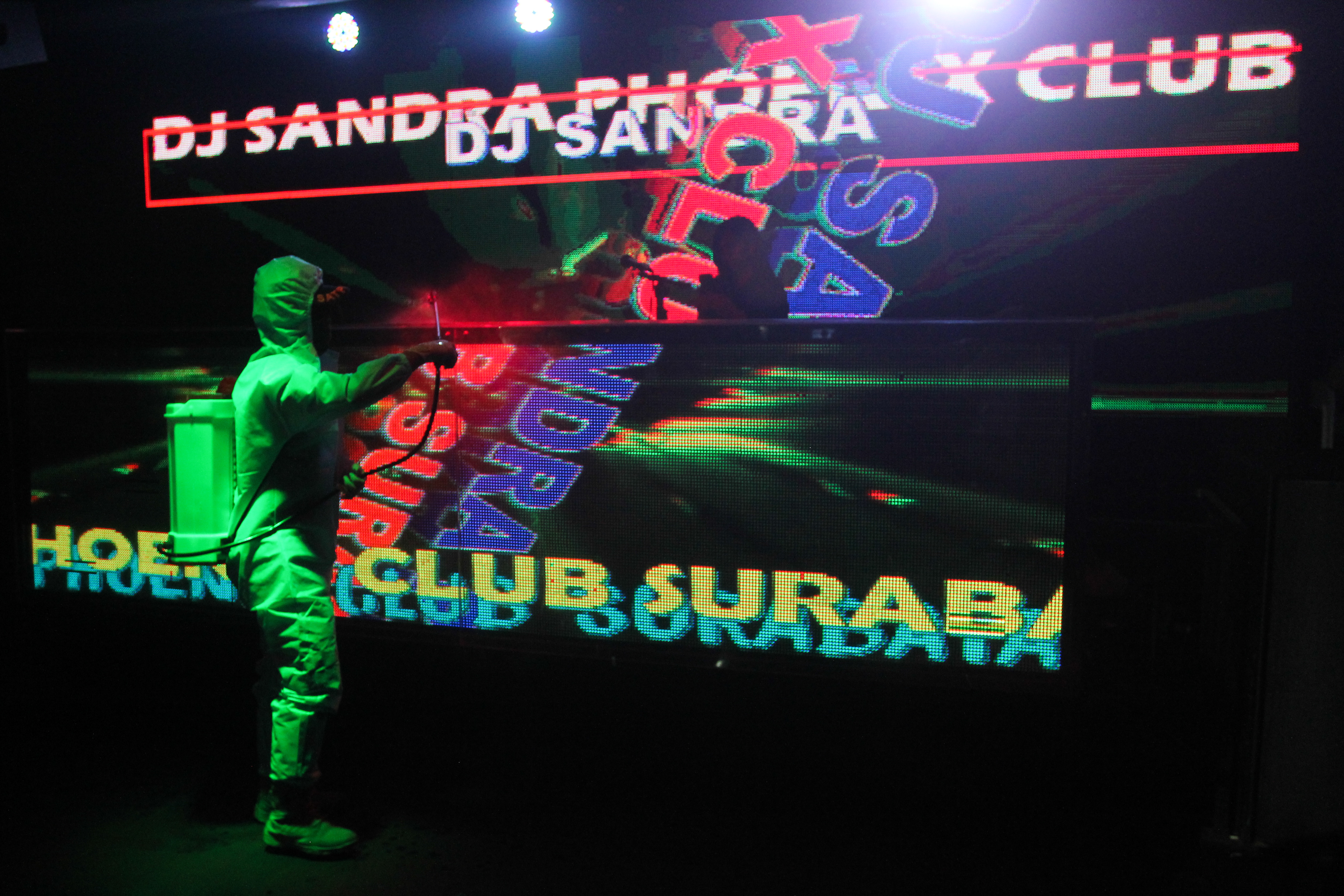 Ilustrasi Petugas menyemprotkan larutan disinfektan saat razia di tempat hiburan malam di Surabaya