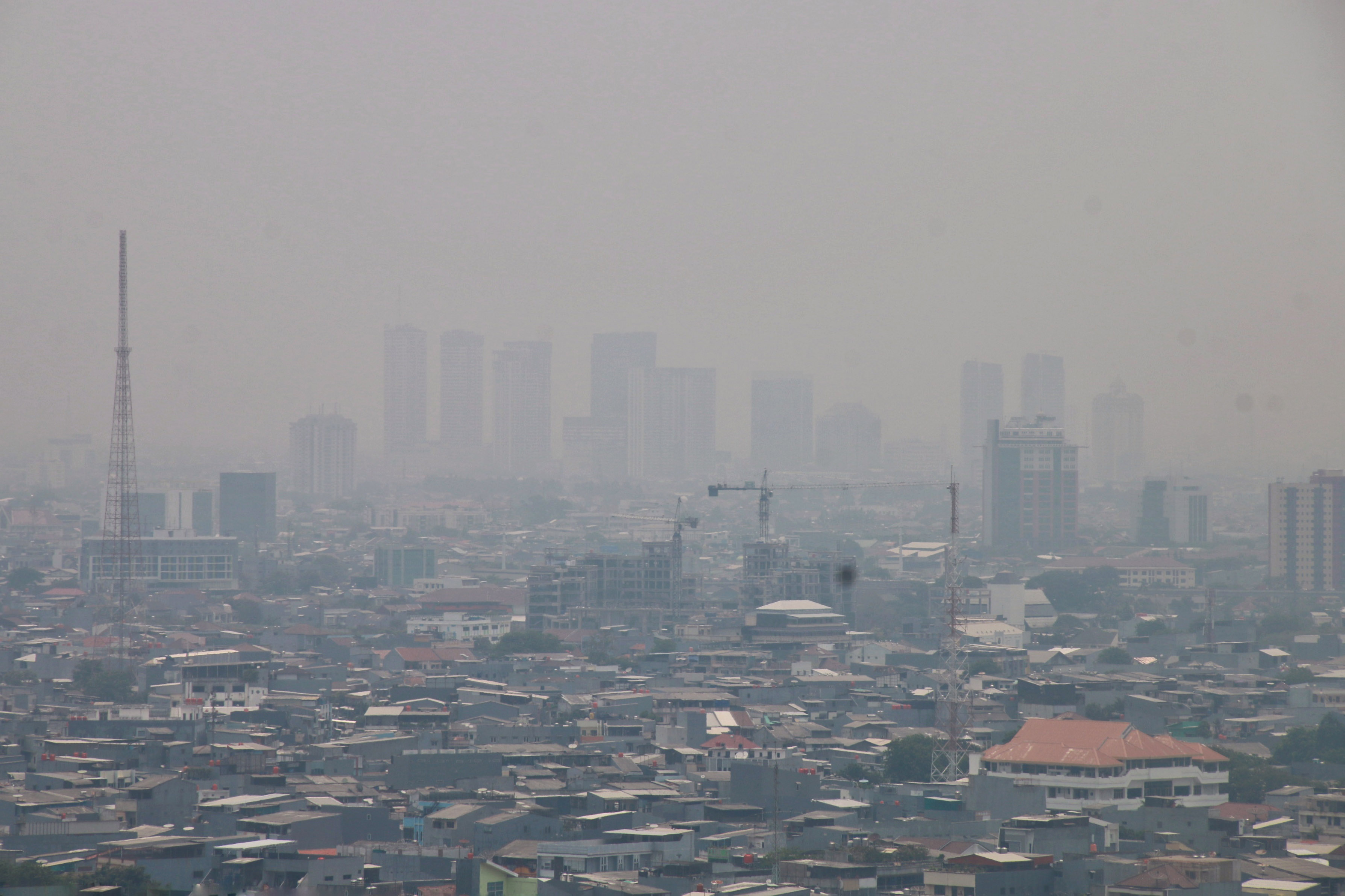 Gedung bertingkat tersamar kabut polusi udara di Jakarta.
