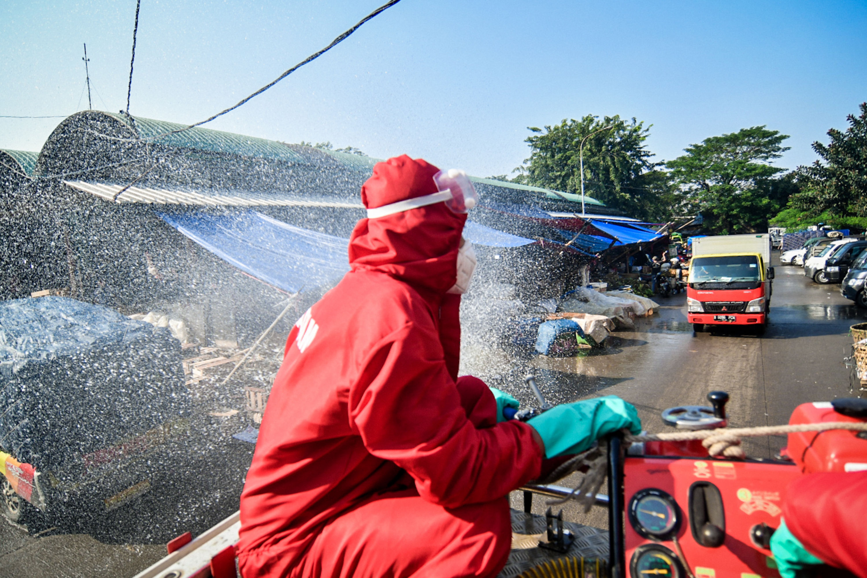  Petugas pemadam kebakaran melakukan penyemprotan disinfektan di Pasar Induk Kramat Jati, Jakarta Timur, Jumat (12/6).