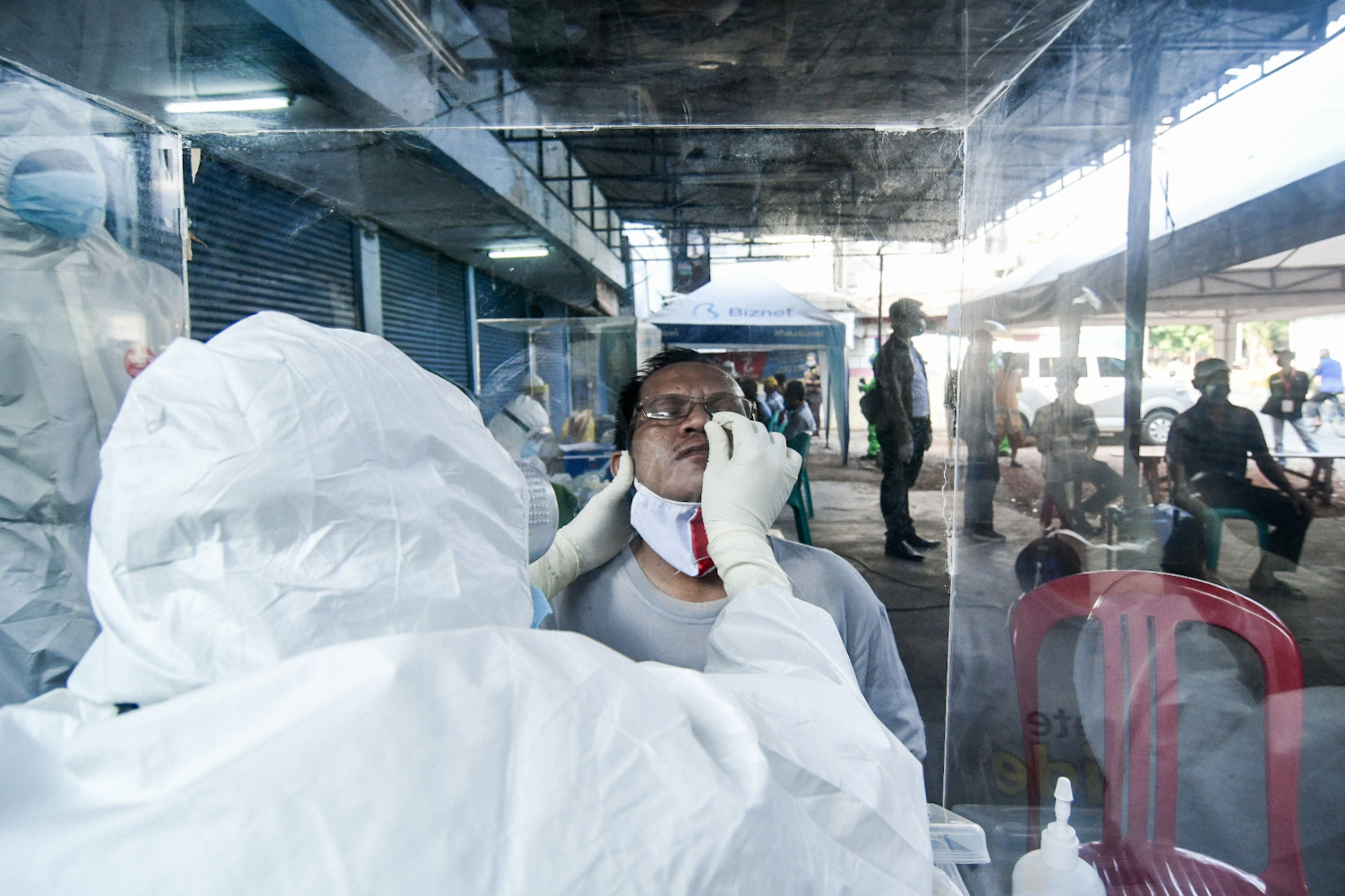 Petugas medis melakukan swab test kepada pedagang pasar di Jakarta