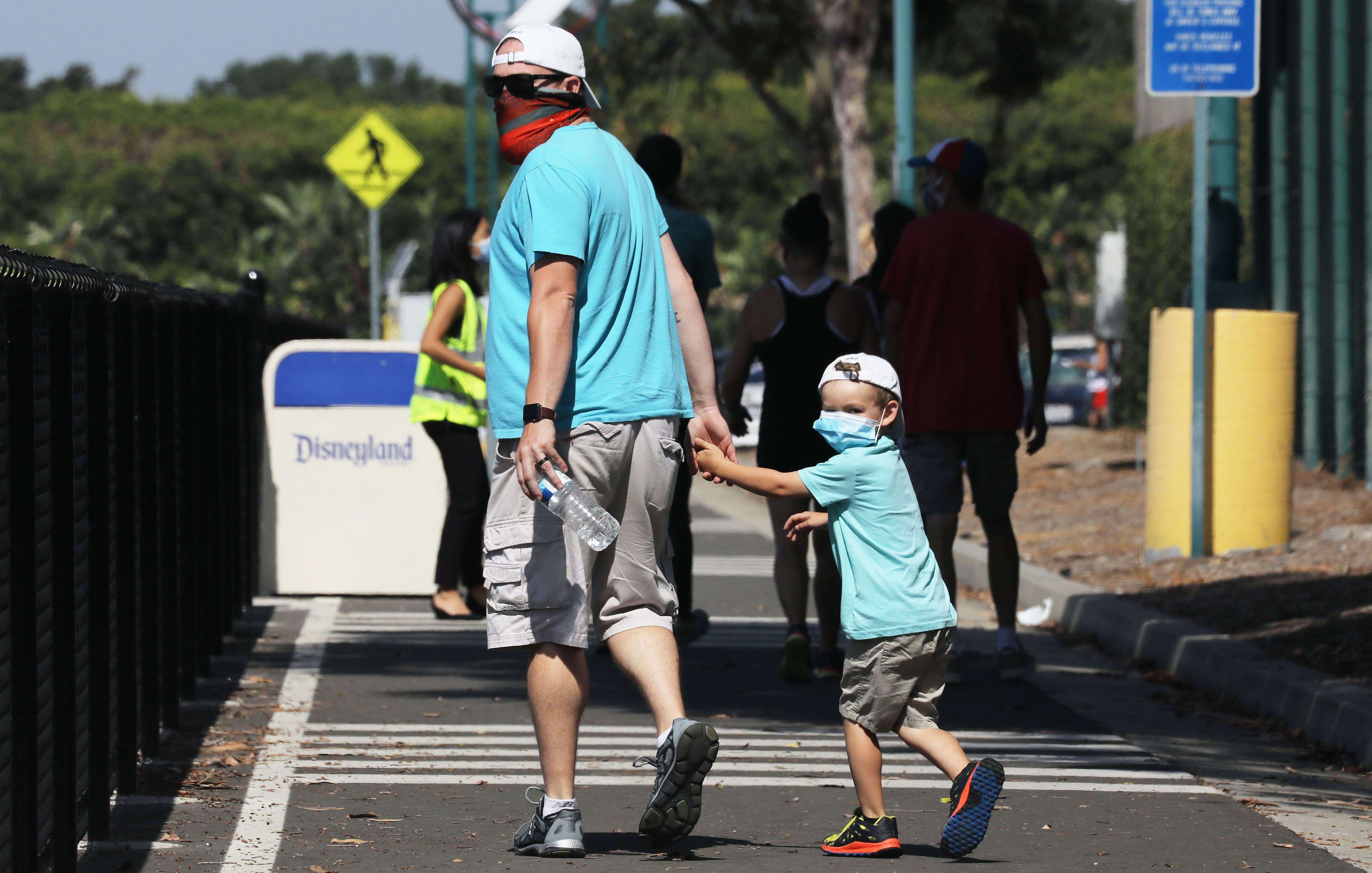 Pengunjung Downtown Disney District menggunakan masker di tengah masifnya penyebaran covid-19 di AS.