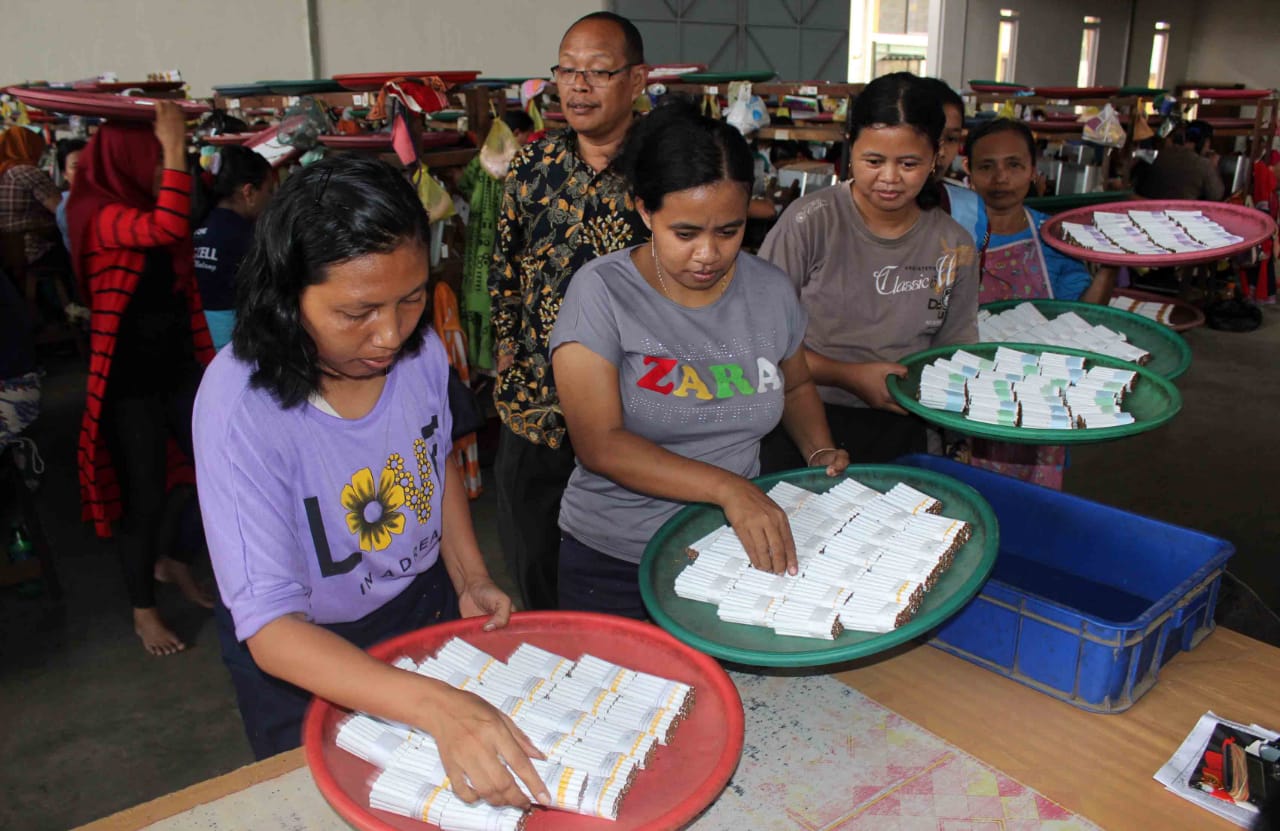 Para karyawan di sebuah perusahaan kecil hasil tembakau di Malang, Jawa Timur