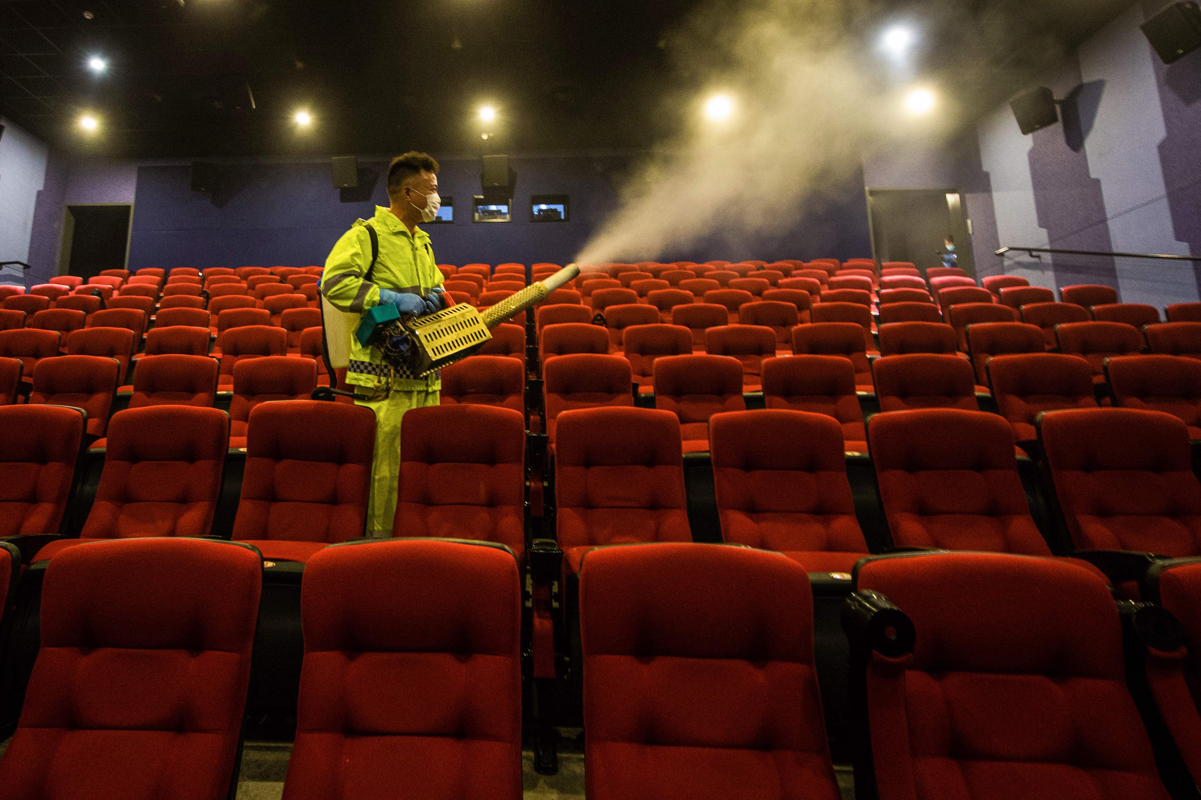 Petugas menyemprotkan disinfektan di dalam sebuah bioskop di Suqian, Provinsi Jiangsu, Tiongkok.
