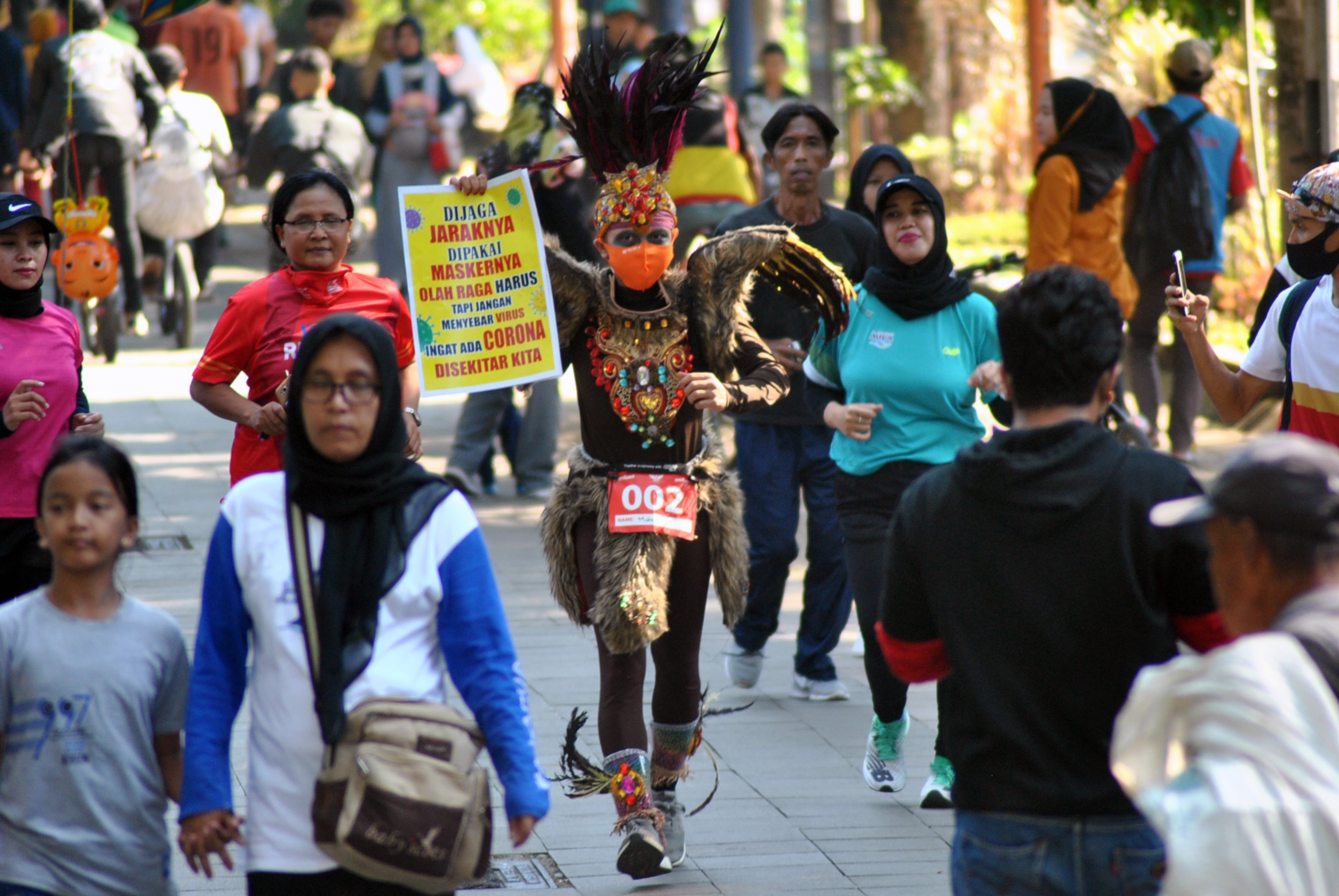 Pelari asal Bogor menggunakan kostum unik untuk kampanye protokol pencegahan covid-19.