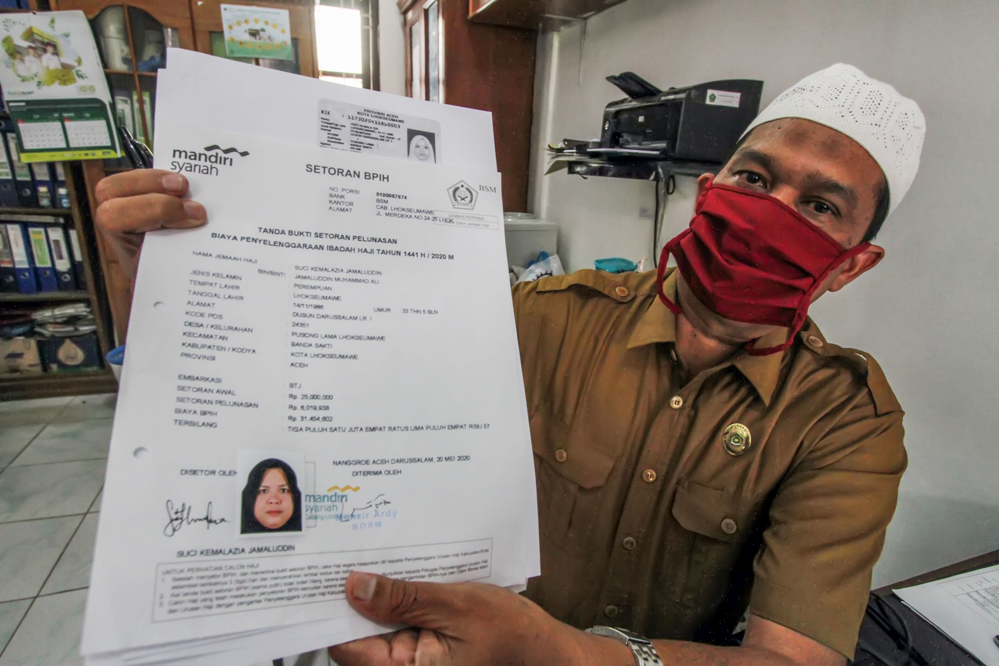 Petugas menunjukkan permohonan pengembalian setoran pelunasan Biaya Perjalanan Ibadah Haji di Kantor Kemenag Lhokseumawe, Aceh Senin (13/7) 