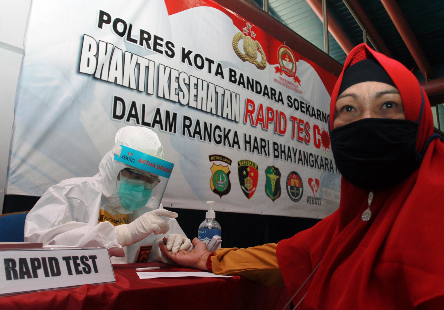 Petugas medis dari Dokkes Polres Metro Bandara Soetta dan Artha Graha Peduli mengambil sampel darah calon penumpang pesawat.