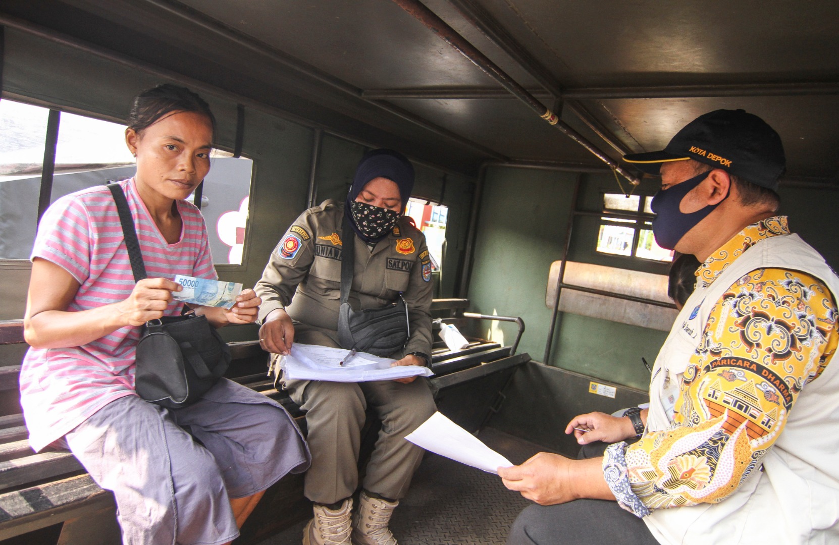 Ilustrasi--Petugas menilang warga yang tidak menggunakan masker di Jalan Margonda Raya, Depok, Jawa Barat.