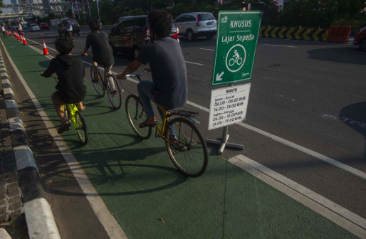 Pesepeda melintasi jalur sepeda di Jalan MH. Thamrin, Jakarta, Minggu (19/7/2020). 