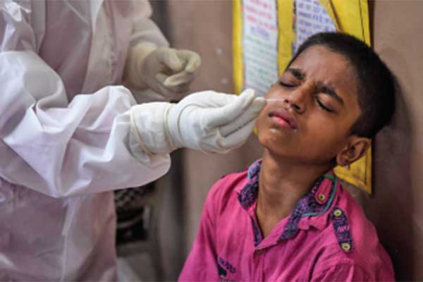 Staf medis mengambil sampel dari seorang anak laki-laki untuk pemeriksaan rapid antigen test covid-19 di New Delhi, India